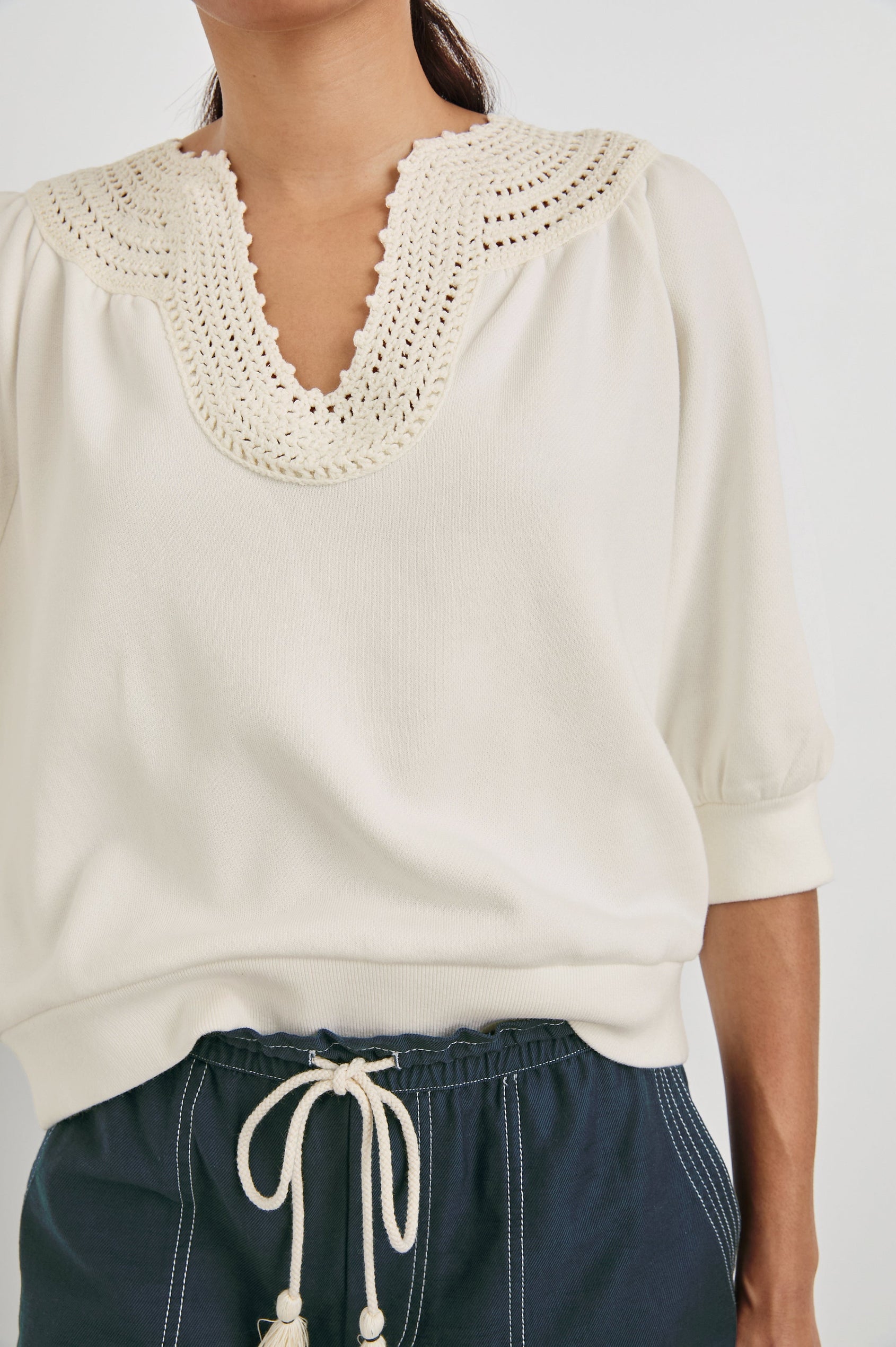 Mariposa Relaxed Fit Top with Elbow Length Sleeves, Tonal Embroidery Details Along Split Neckline in Ivory Colorway. Front Detailed View Shown on Model.