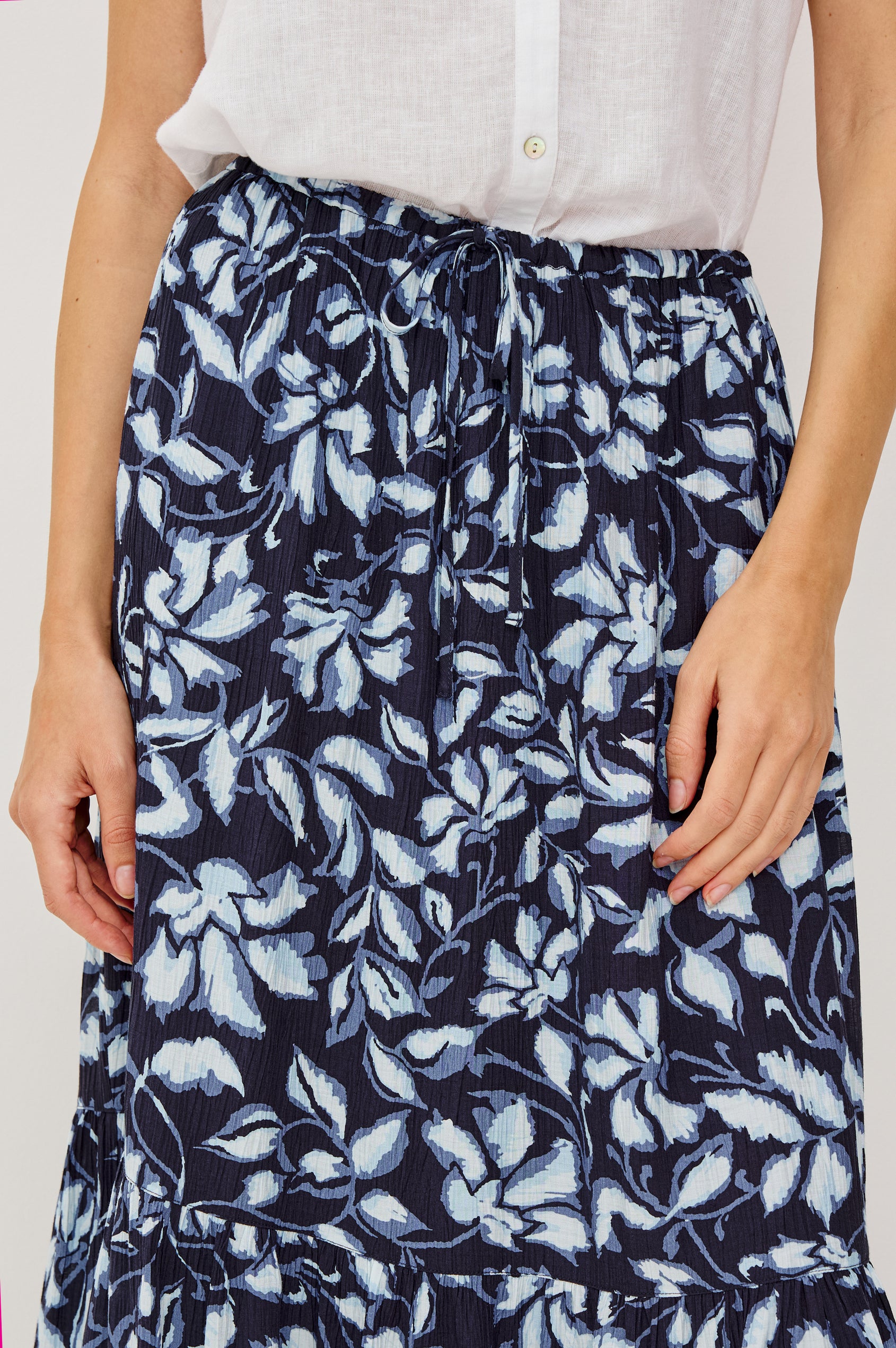 Marulo High-Waisted Floral Maxi Skirt in Pleated Chiffon With Adjustable Drawstring Ties, Single Tier Seam, and Full Interior Lining in Navy Jasmine Colorway - Lower Body Front Close Up VIew Featured on Model