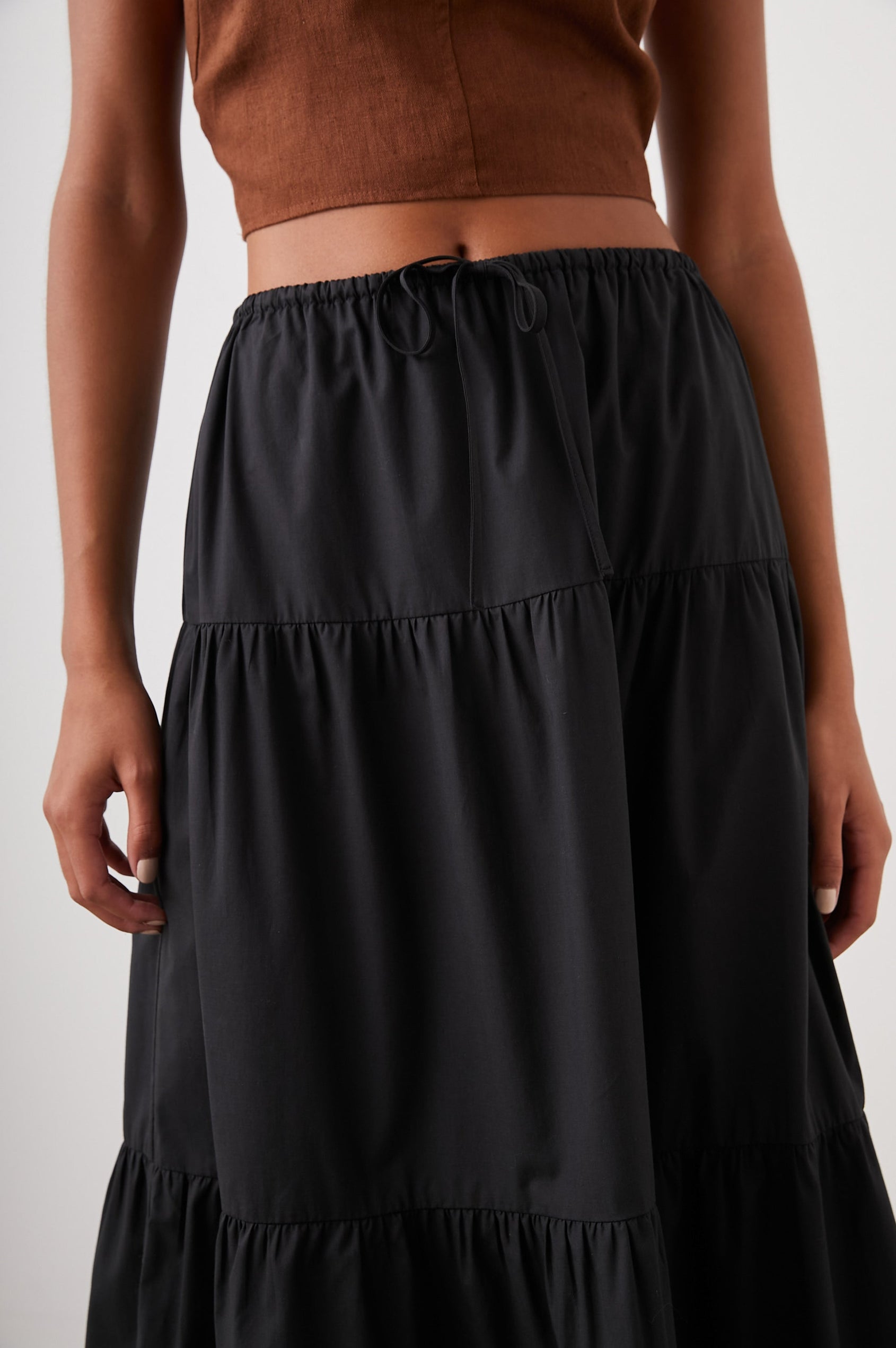 Mary Tiered Midi Skirt with a Drawstring Waist in Black Colorway - Front View Featured on Model