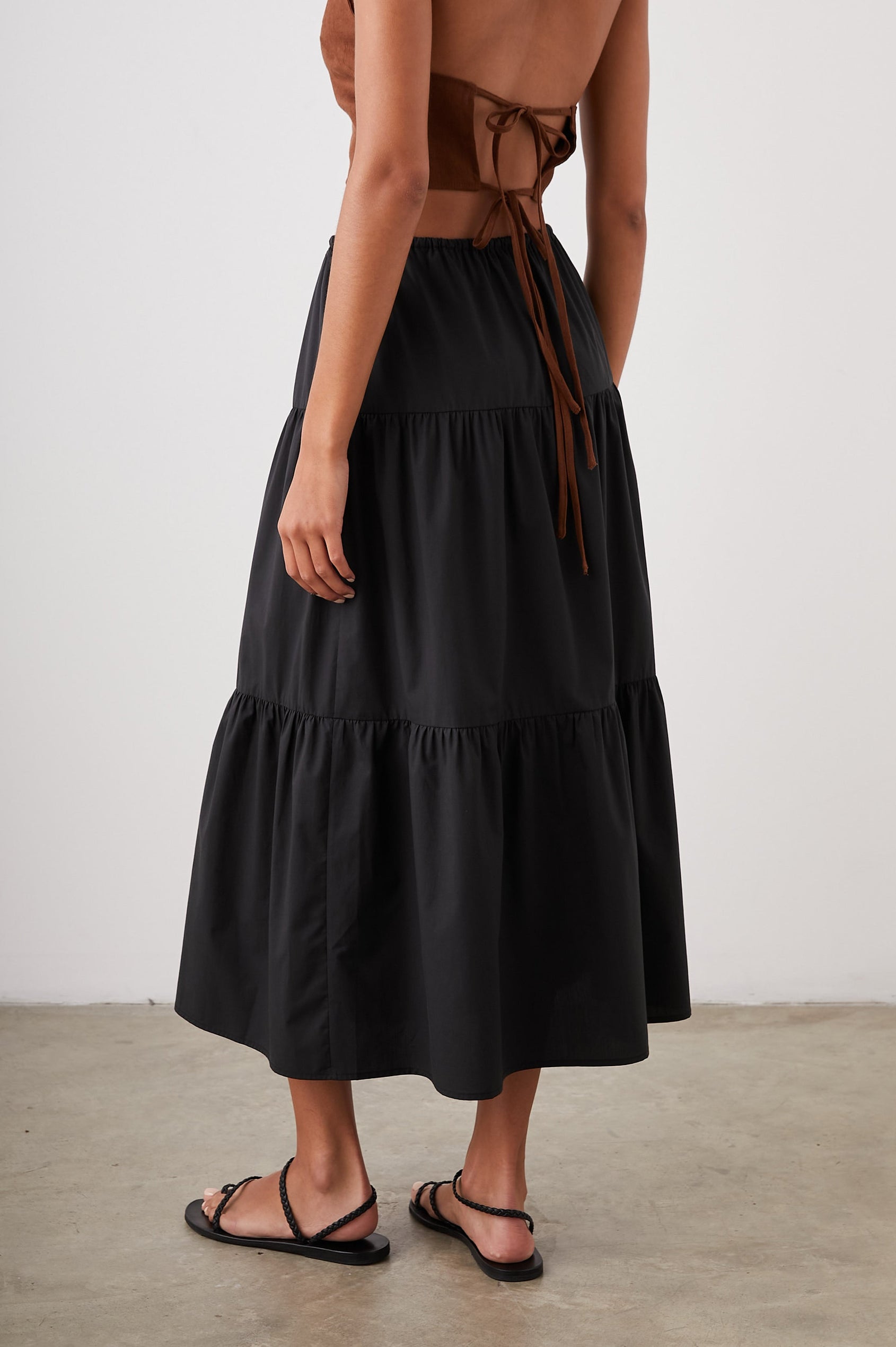Mary Tiered Midi Skirt with a Drawstring Waist in Black Colorway - Back View Featured on Model