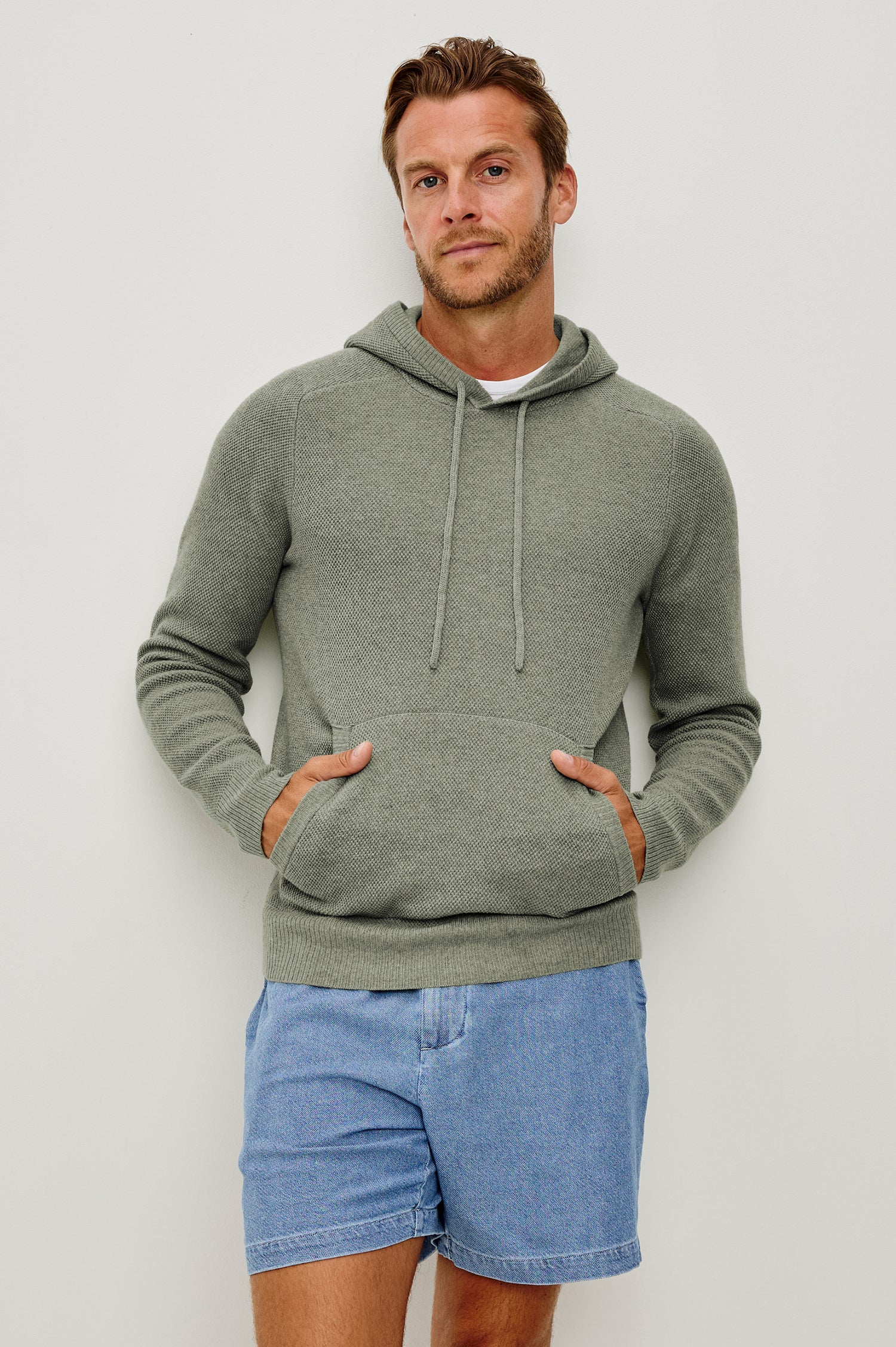 Matador Hoodie Sweatshirt in Cotton Blend With Drawstring TIes, Front Kangaroo Pockets, and Long Sleeves in Sage Heather - Upper Body Front View Featured on Model