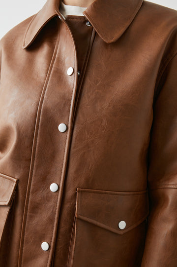 Mathis Faux Leather Jacket with Snap Closure and Two Front Snap Flap Pockets in Russet Colorway - Front View Featured on Model  