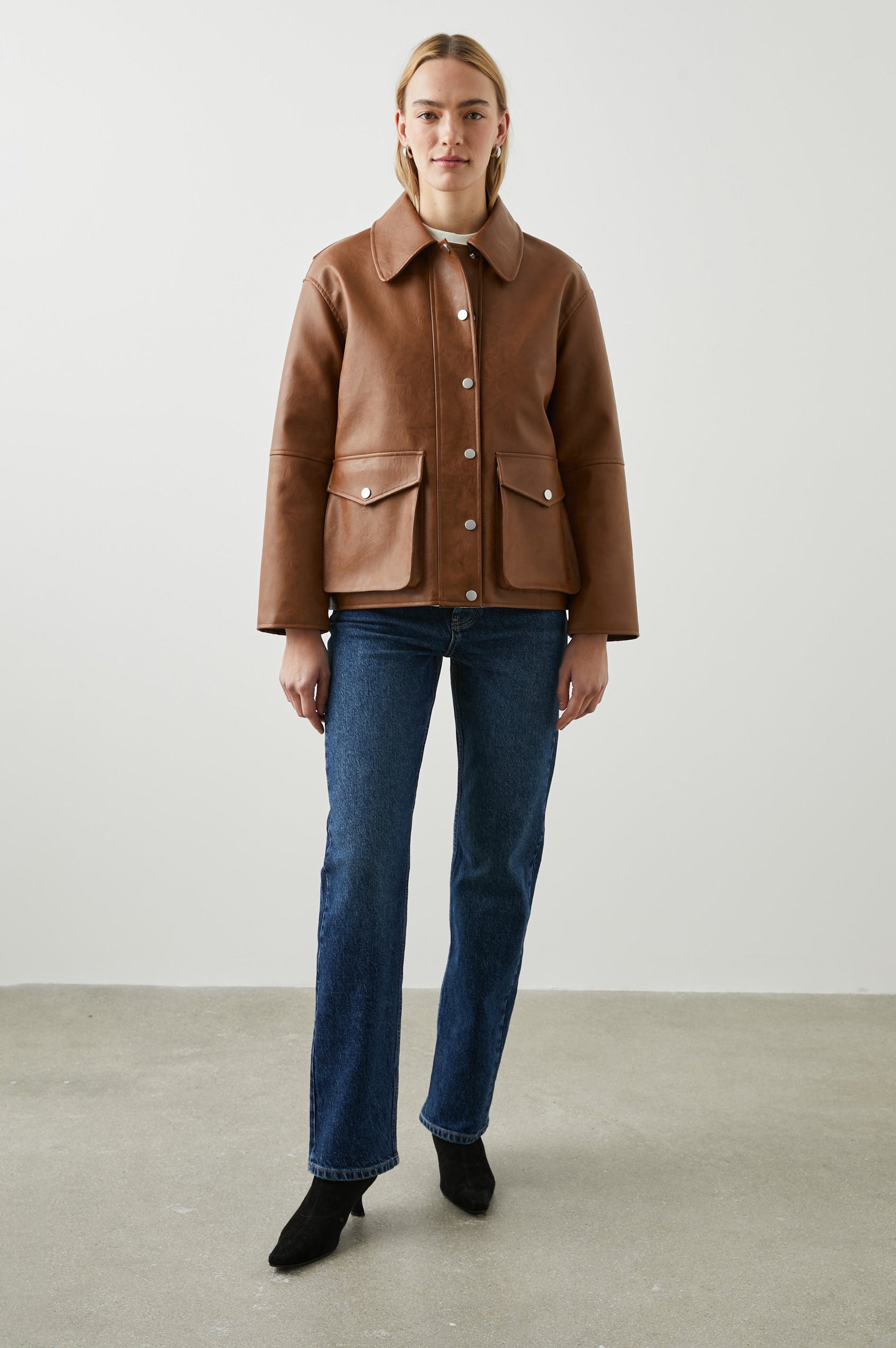 Mathis Faux Leather Jacket with Snap Closure and Two Front Snap Flap Pockets in Russet Colorway - Front Full Body View Featured on Model  