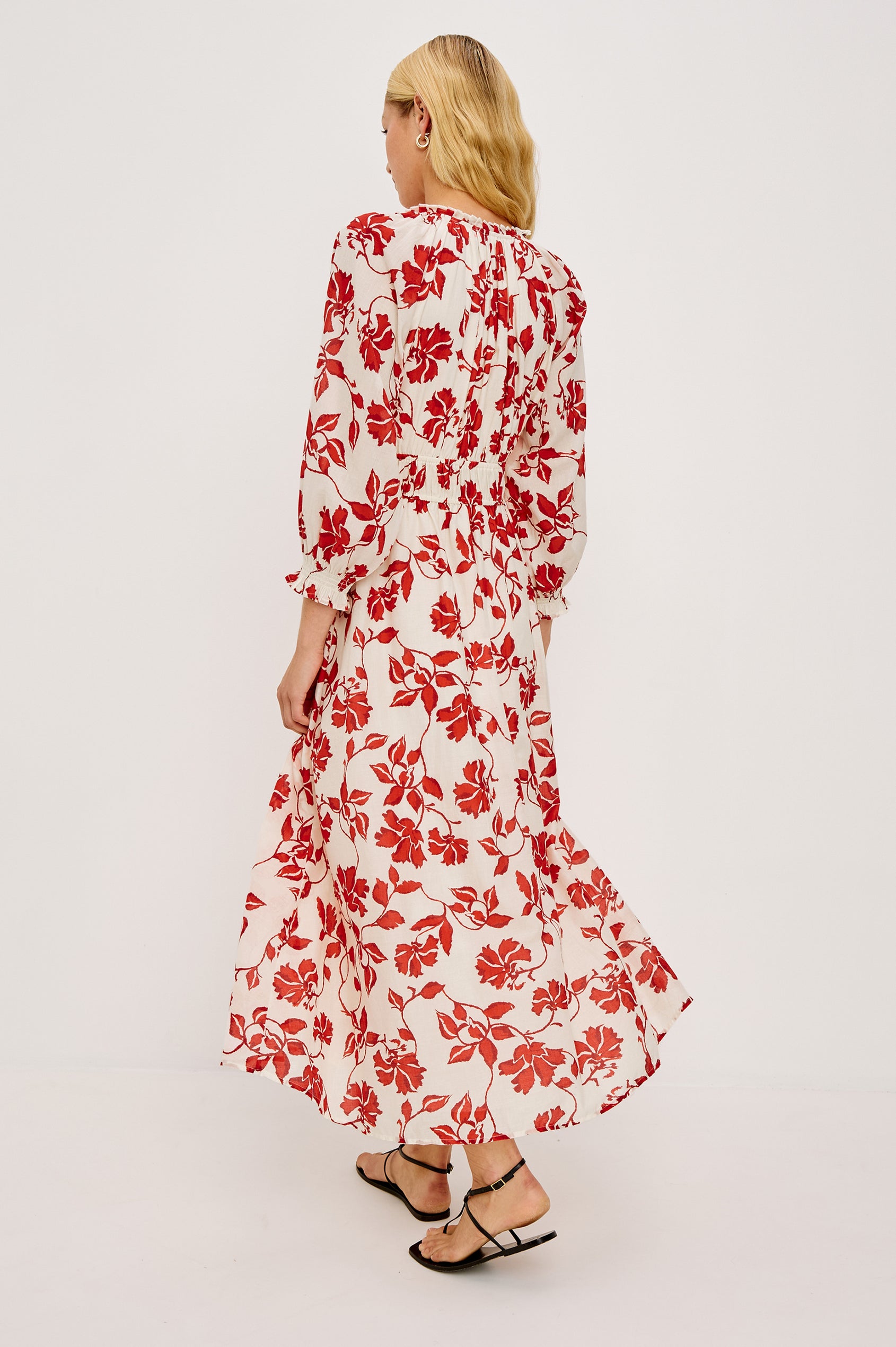 Matia Maxi Dress in Cotton With Banded Ruffle V-Neckline With Self-Ties Elastic Waist and Long Raglan Puff Sleeves in Red Jasmine Colorway - Full Body Back View Featured on Model