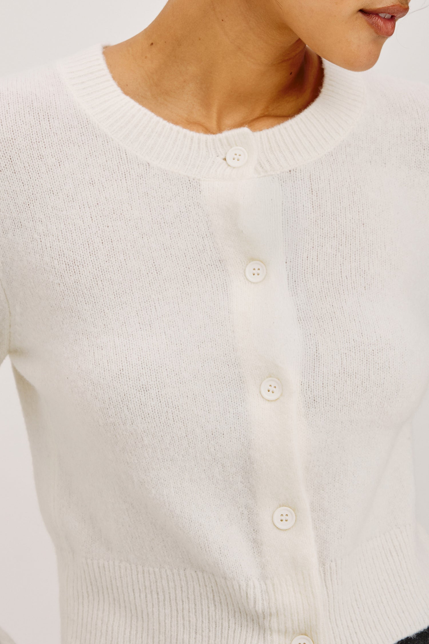 Matilda Cardigan in Wool-Blend Knit WIth Relaxed Slightly Cropped Fit, Crew Neck, Front Buttons, and Ribbed Trim in Ivory Colorway - Upper Body Front View Featured on Model