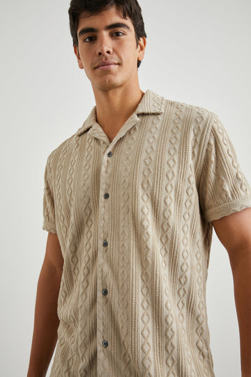 Maverick Short Sleeve Button Up with a raised jacquard pattern in Craft Paper Colorway, a Light Brown - Front View Featured on Model