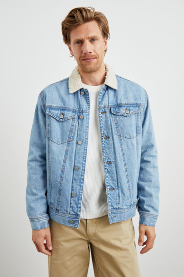 McKinley Denim Jacket with Button Closure, Two Chest Button Flap Pockets and a Cream Faux Sherpa Collar in Vintage Wash Colorway - Front View Featured on Model