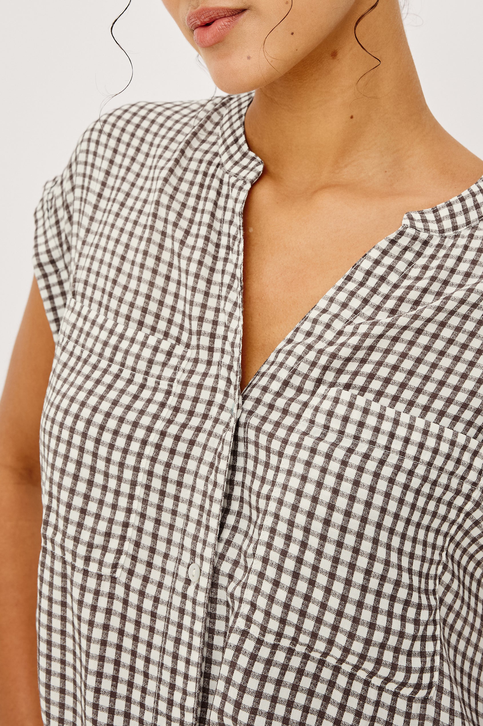 Mel Boxy Button-Up Shirt With Ruffled Cap Sleeves Banded V-Neckline Front Buttons Chest Patch Pockets and Curved High Neckline in Espresso Gingham - Upper Body Close Up Front View Featured on Model