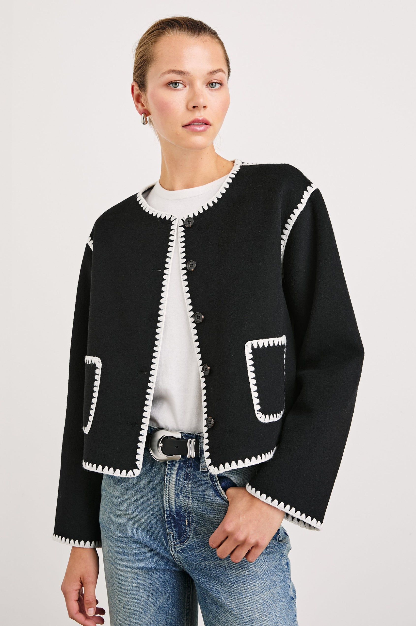 Melanie Jacket with Button Closure and Two Front Patch Pockets in Black Colorway, with White Stitching along the Trim and Pockets - Front View Featured on Model