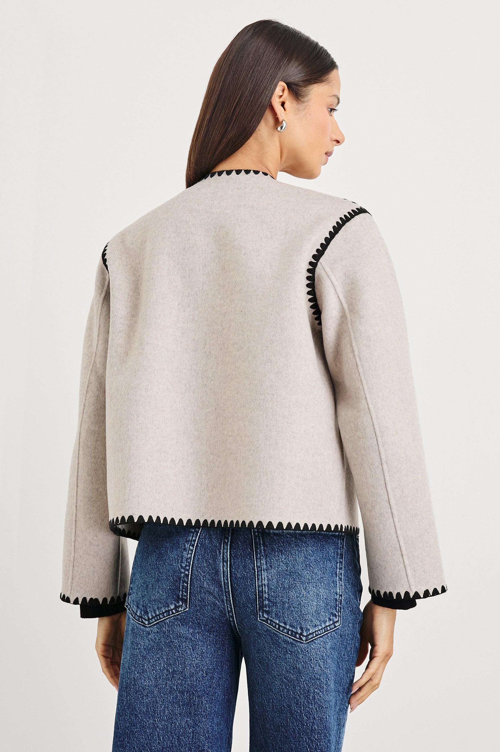 Melanie Jacket with Button Closure and Two Front Patch Pockets in Oatmeal Colorway, with Black Stitching along the Trim and Pockets - Back View Featured on Model