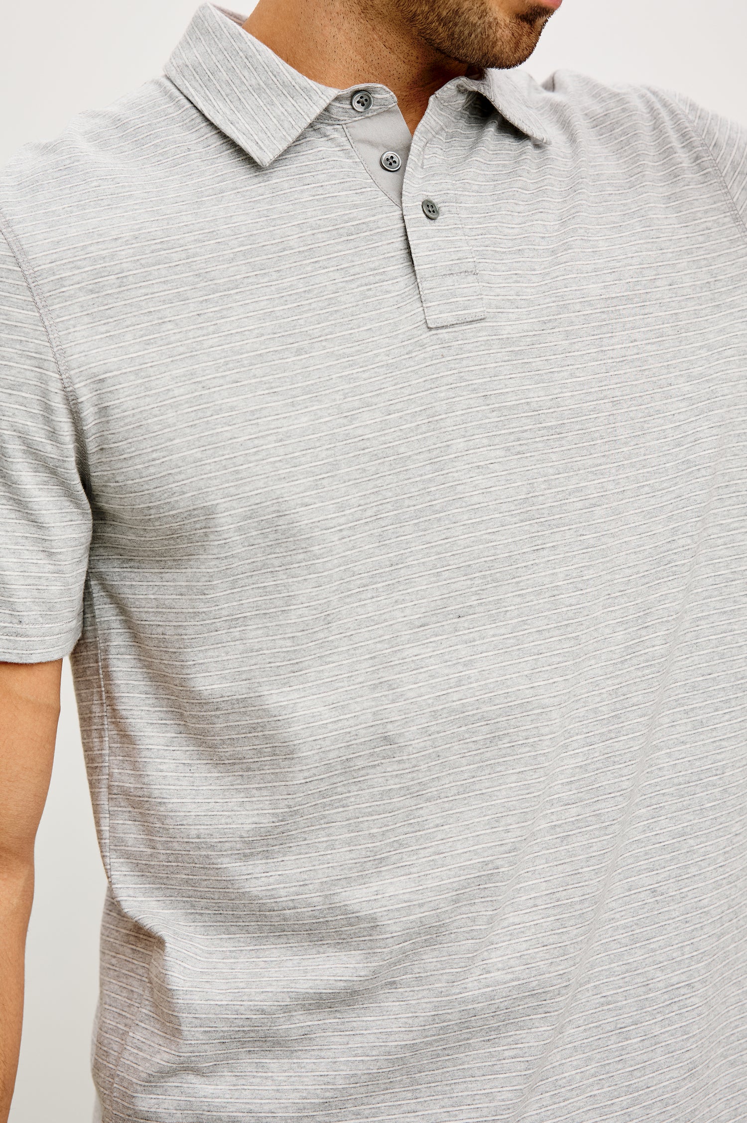 Merced Golf Polo in TENCEL™ Poly Blend With Collar, Quarter Placket, Short Sleeves, and Classic Fit in Heather Grey Stripe Colorway - Upper Body Front View Featured on Model