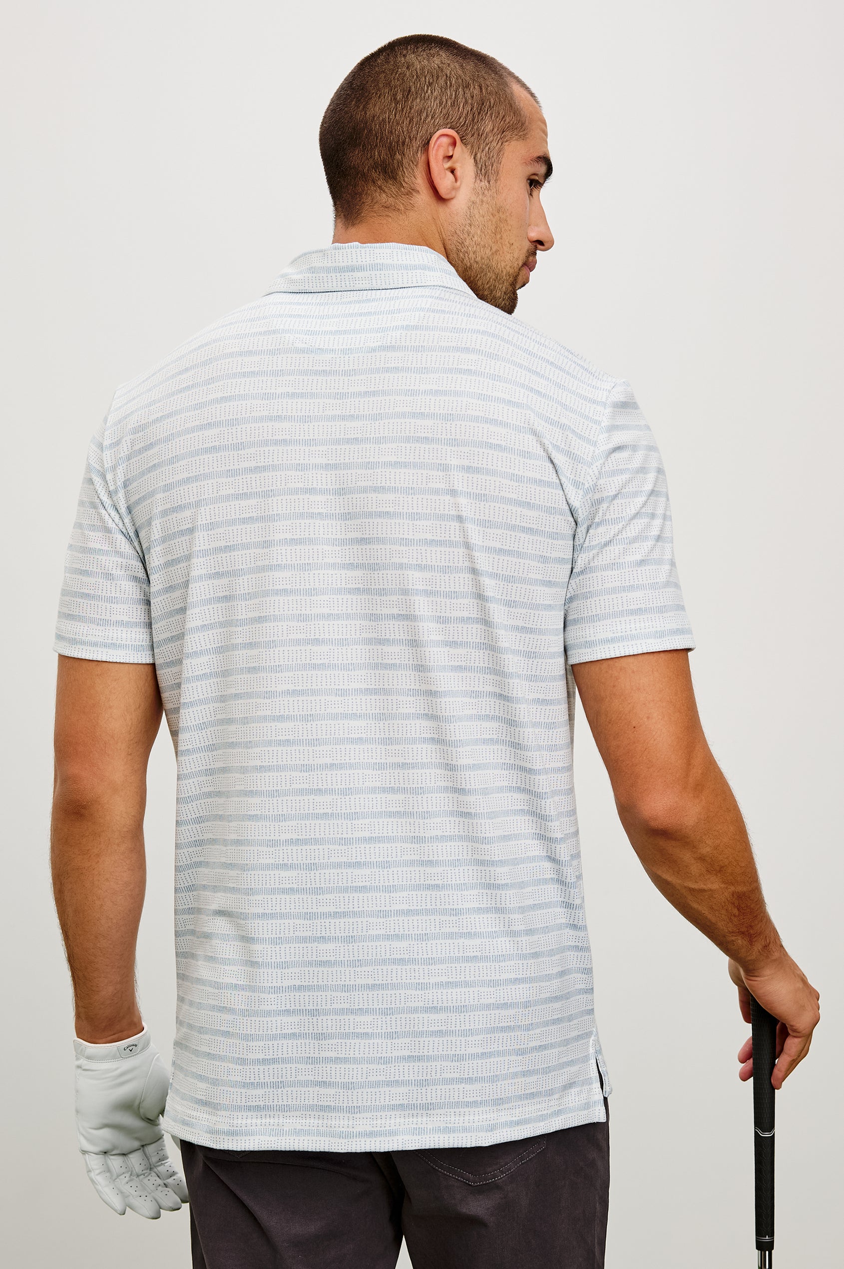 Merced Golf Polo in TENCEL™ Poly Blend With Collar, Quarter Placket, Short Sleeves, and Classic Fit in Shashiko Border White Colorway - Upper Body Back View Featured on Model