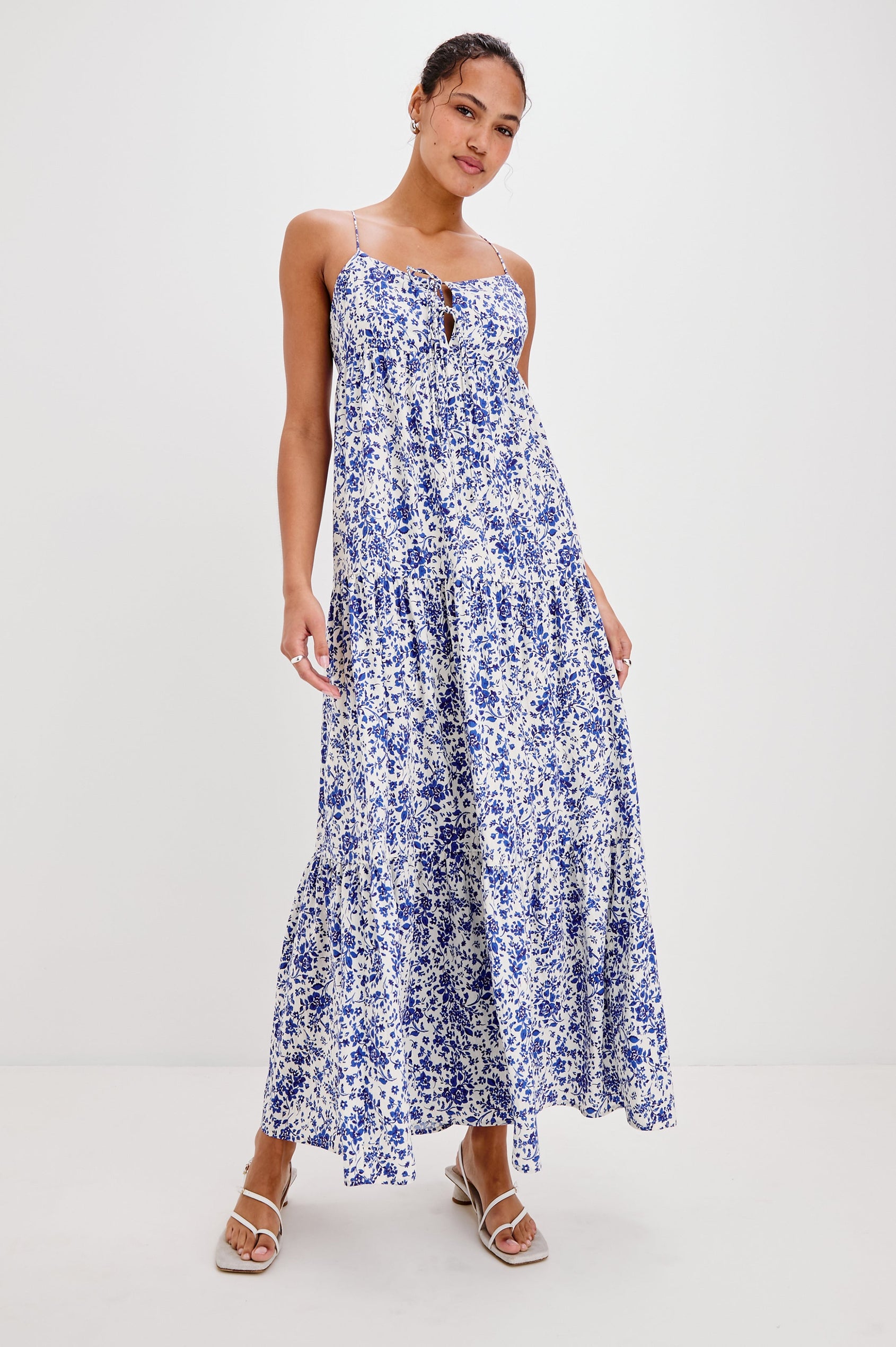 Mica Midi Tank Dress with and Empire Waist, Spaghetti Straps, a Keyhole at Center Front, Ties and a Tiered Skirt in Blue Marguerite Colorway. Front View Shown on Model.