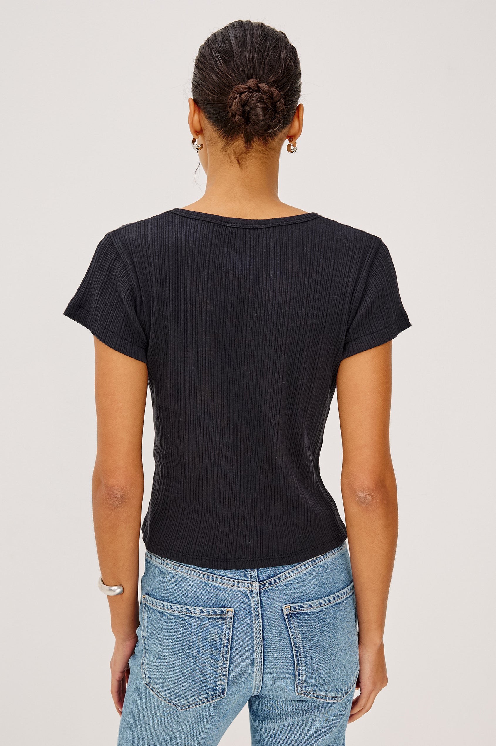 Mickey Fitted Crewneck Short Sleeve Baby Tee With Pleated Rib Pointelle Detailing in Black Colorway - Upper Body Back View Stylized Featuerd on Model
