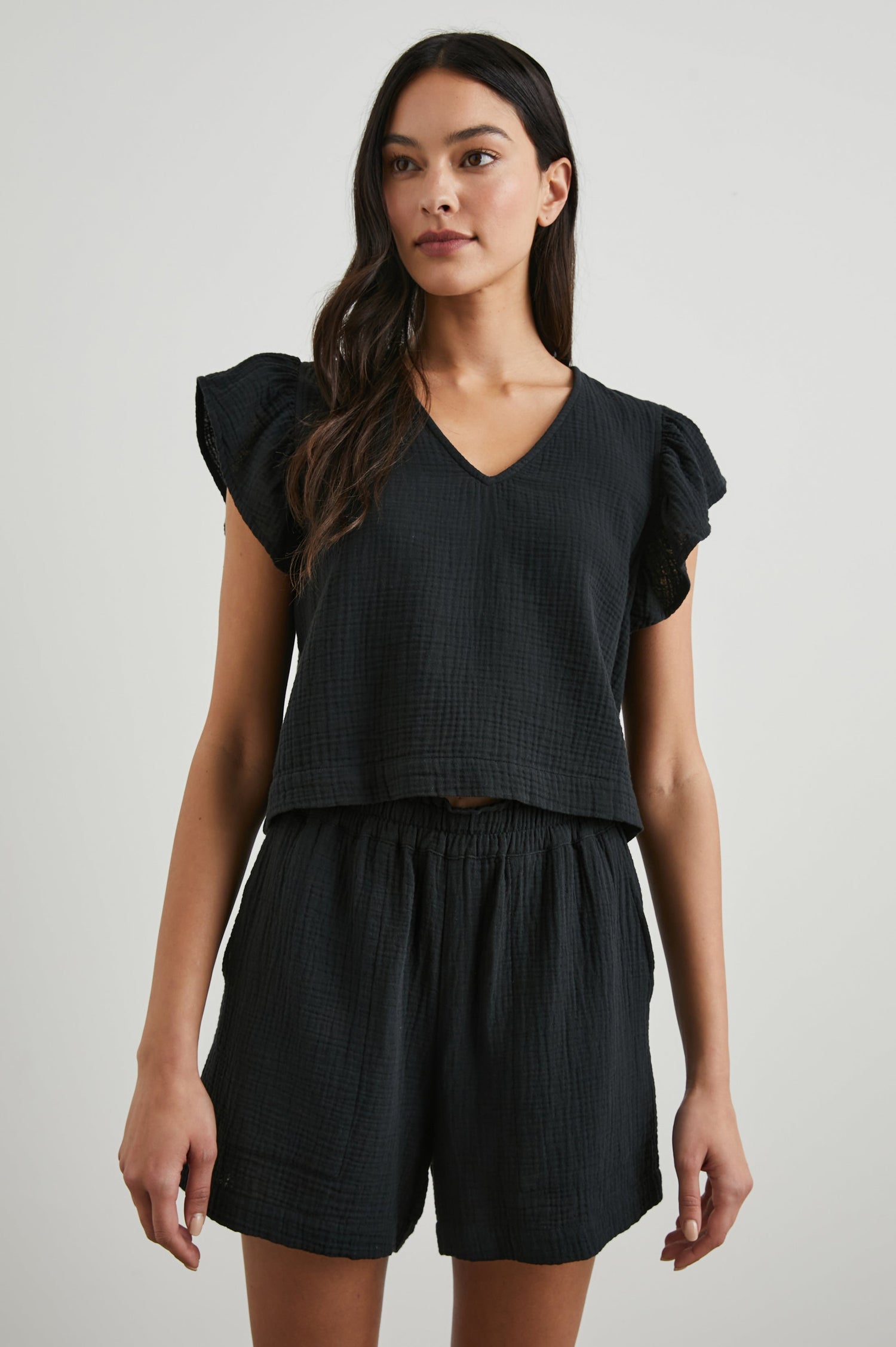Miley Cropped, Short-Sleeve, V Neck Top with Flutter Sleeves and Textured Fabric in Black Colorway - Front View Featured on Model
