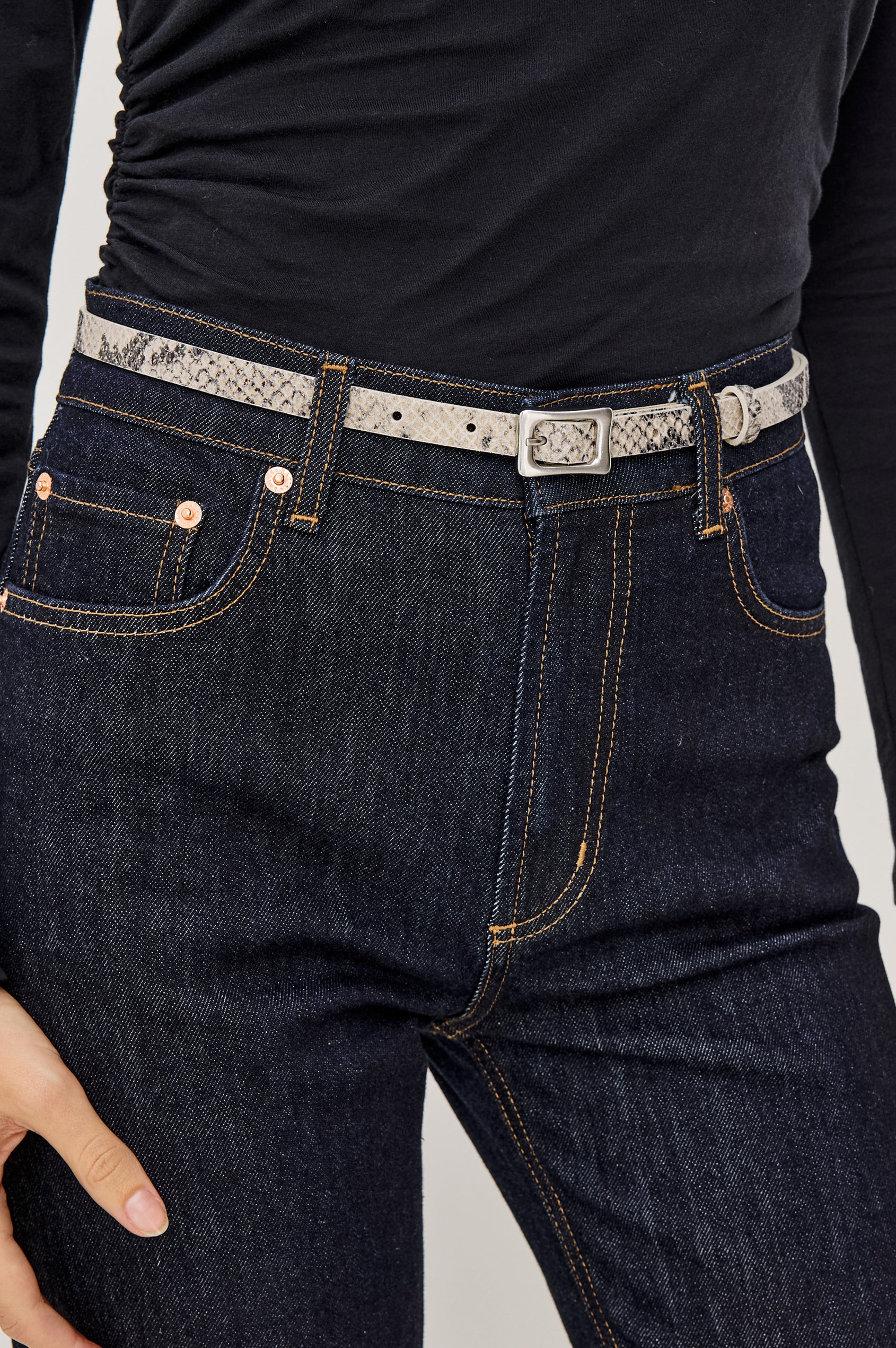 Remi Slim Leather Belt With Adjustable Buckle Closure in Ecru Python Colorway - Close Up Front Mid Body View Featured on Model