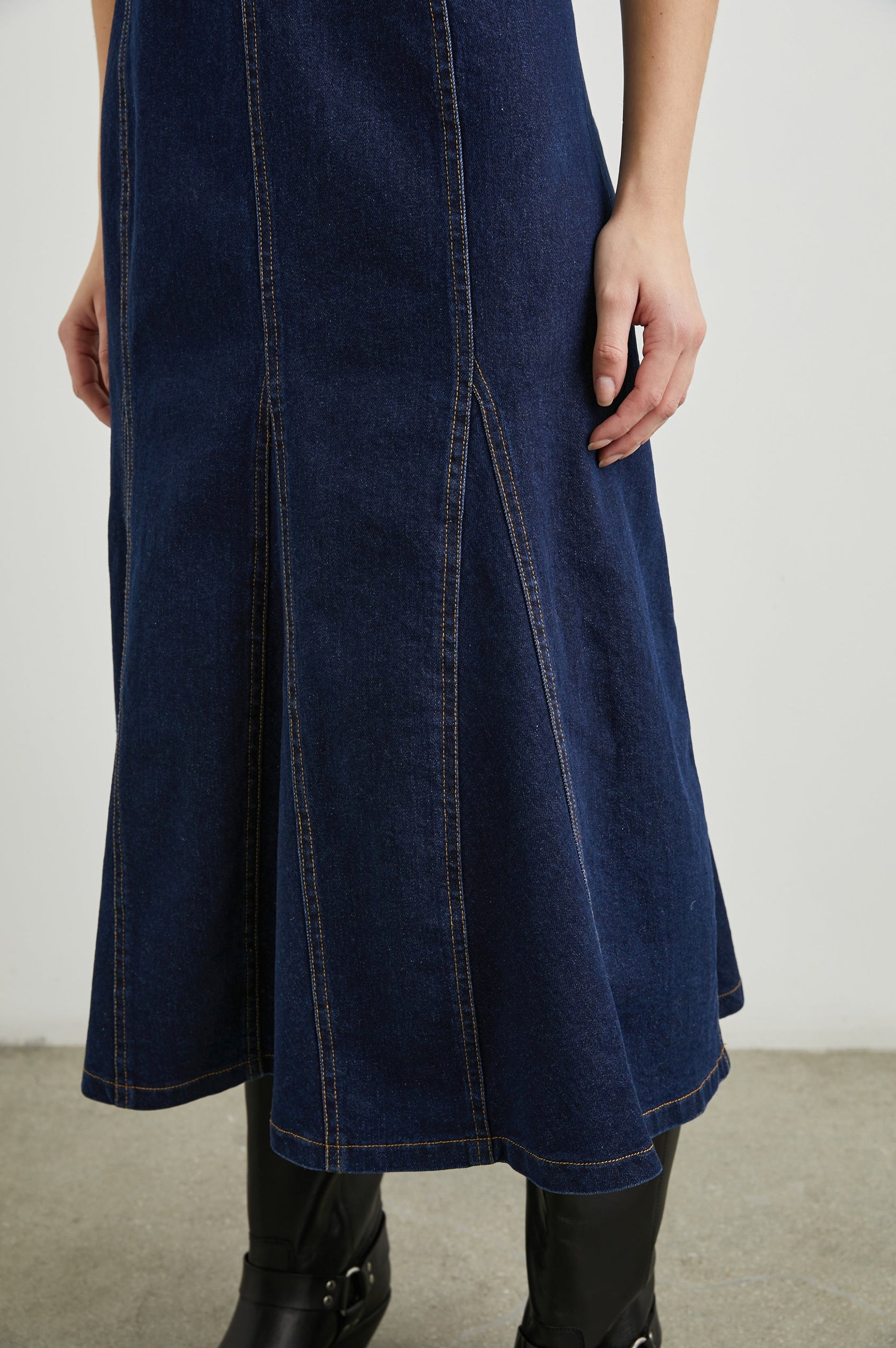 Minna Sleeveless Denim Midi Dress with Shoulder Straps, a Scoop Neck, Darting Details, and a Half Zippered Back in Rinse Indigo Colorway - Front View Featured on Model   
