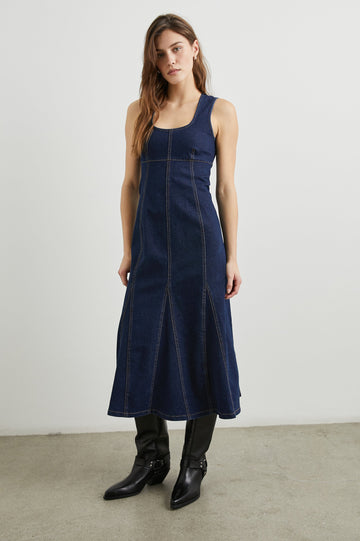 Minna Sleeveless Denim Midi Dress with Shoulder Straps, a Scoop Neck, Darting Details, and a Half Zippered Back in Rinse Indigo Colorway - Front Full Body View Featured on Model   