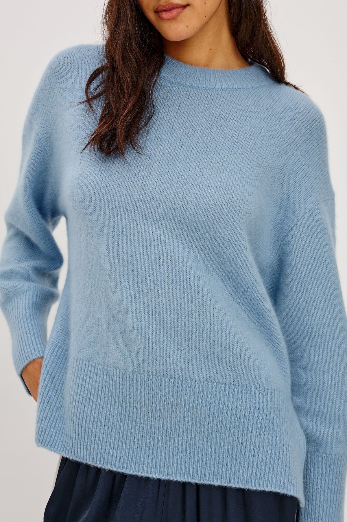 Miranda Sweater in Cashmere-Silk Blend With Relaxed Boxy Fit, Mock Neck, Drop Shoulders, and Side Slits at Hem in Fjord Blue Colorway - Upper Body Front Detail View Featured on Model.