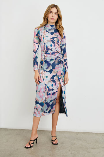 Mona Long Sleeve Midi Dress with a Mock Neck, a Side Slit and Adjustable Ruching along the Left Side with a Drawstring in Midnight Verbena Colorway, Flowers in Pinks, Browns, Greens and Blues on Midnight - Front Full Body View Featured on Model 