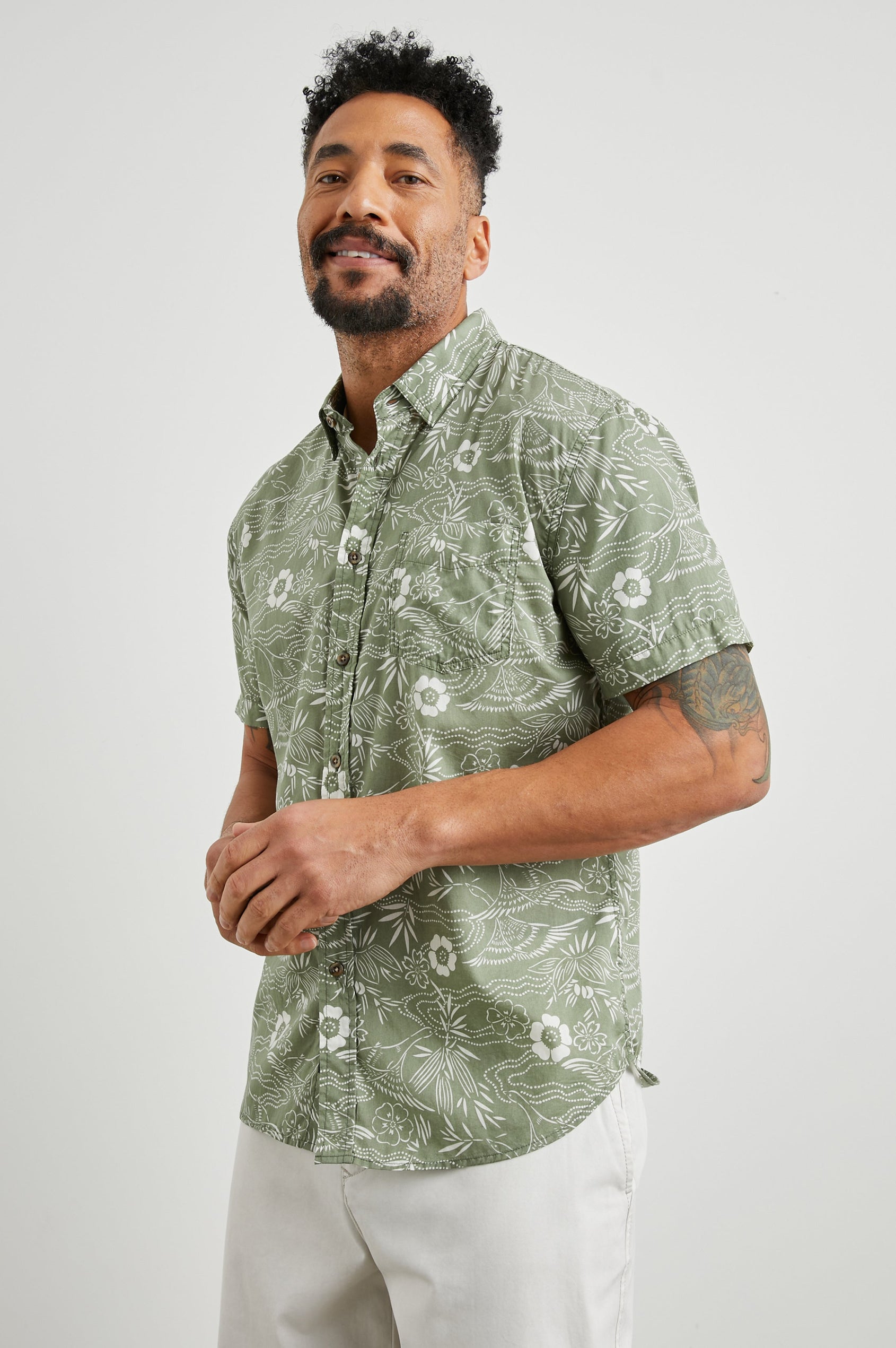 Monaco Short-Sleeve Button Up with a Chest Patch Pocket in Japanese Stencil Fatigue Colorway, a White Floral Print on Fatigue - Front View Featured on Model