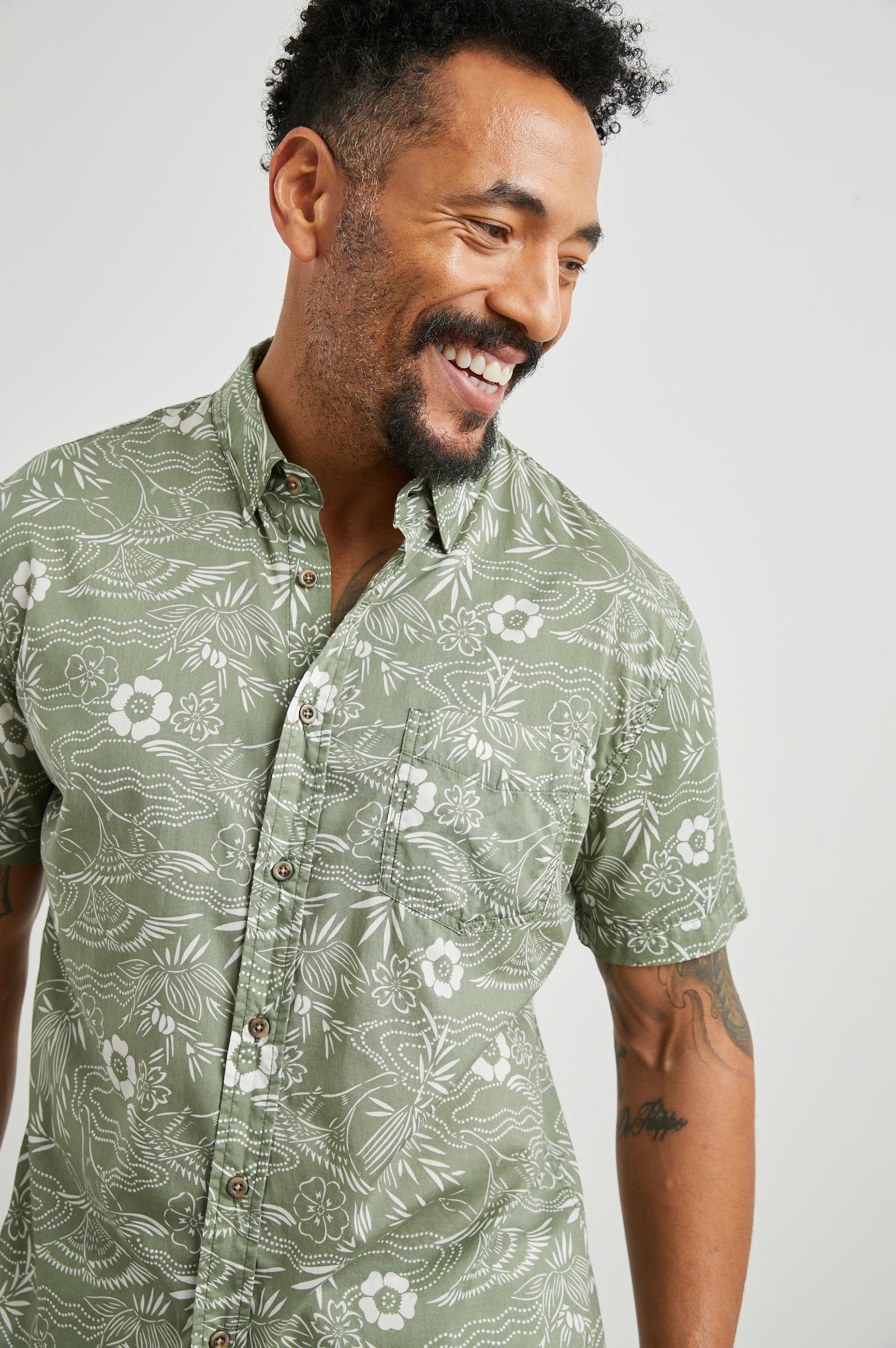 Monaco Short-Sleeve Button Up with a Chest Patch Pocket in Japanese Stencil Fatigue Colorway, a White Floral Print on Fatigue - Front View Featured on Model