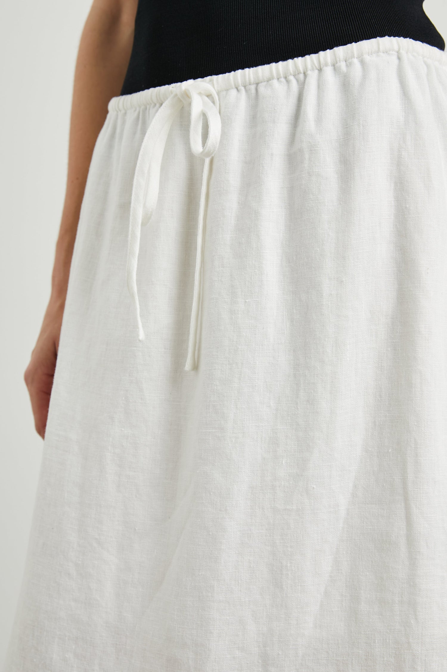 Monet Midi Skirt with Two Side Slits and a Drawstring Waist in White Colorway - Front View Featured on Model 