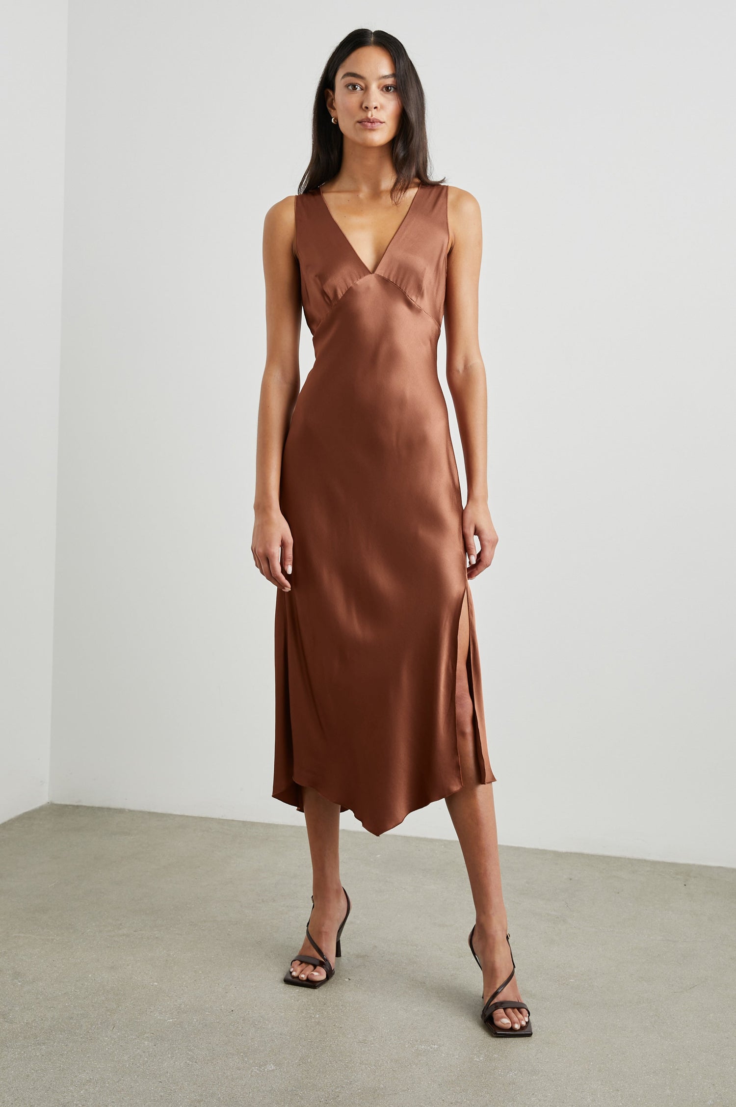 Monique Sleeveless Midi Dress with an Asymmetrical Hem Line, Side Slit, Deep V Neck, and Wide Shoulder Straps in Cedar Colorway - Front Full Body View Featured on Model