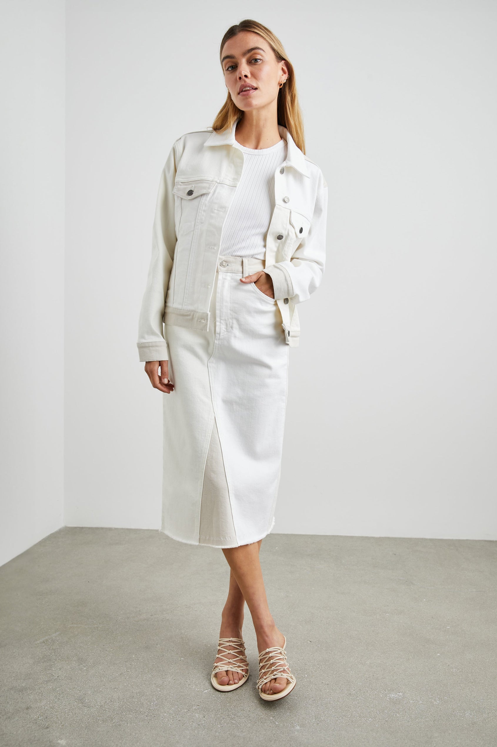 Mulholland Denim Jacket with Button Closure, Two Chest Button Flap Pockets, Two Front Pockets, Adjustable Button Straps on Hem in Ecru Patchwork Colorway, Patches of Neutral Colors - Front Full Body View Featured on Model  