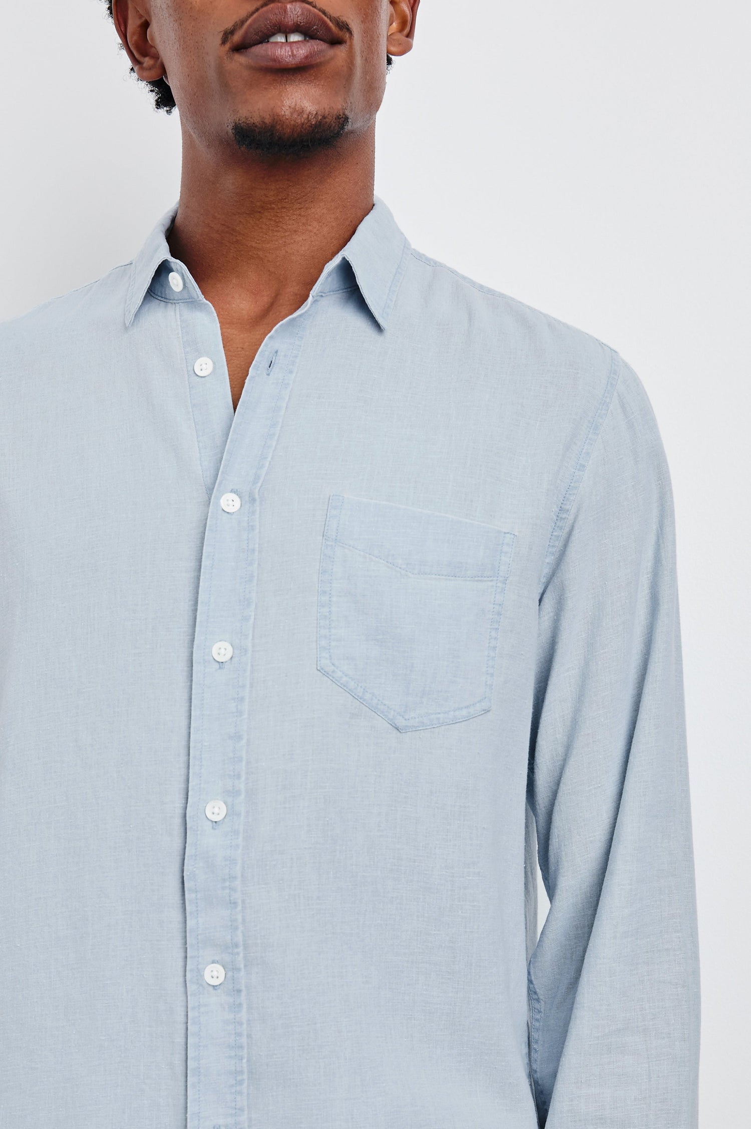 Mykonos linen button up long sleeve with front chest pocket and collar in Blue Lagoon - close up of details on model