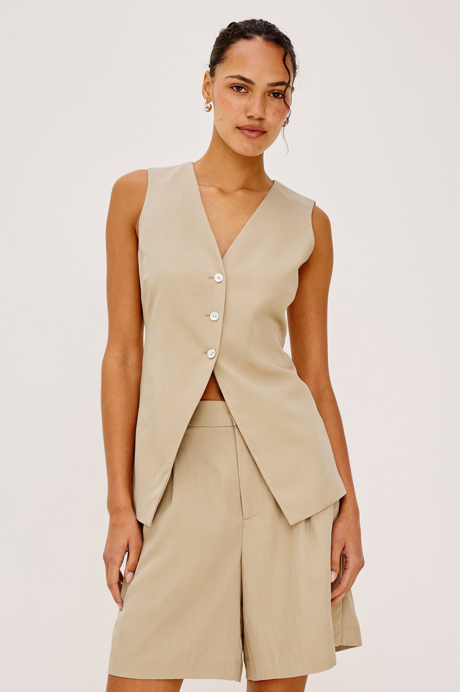 Mylah Vest in Viscose Suiting With V-Neckline, Front Buttons, and Slightly-Loose Fit Tapered at Waist in Almond Colorway - Upper Body Front View Featured on Model