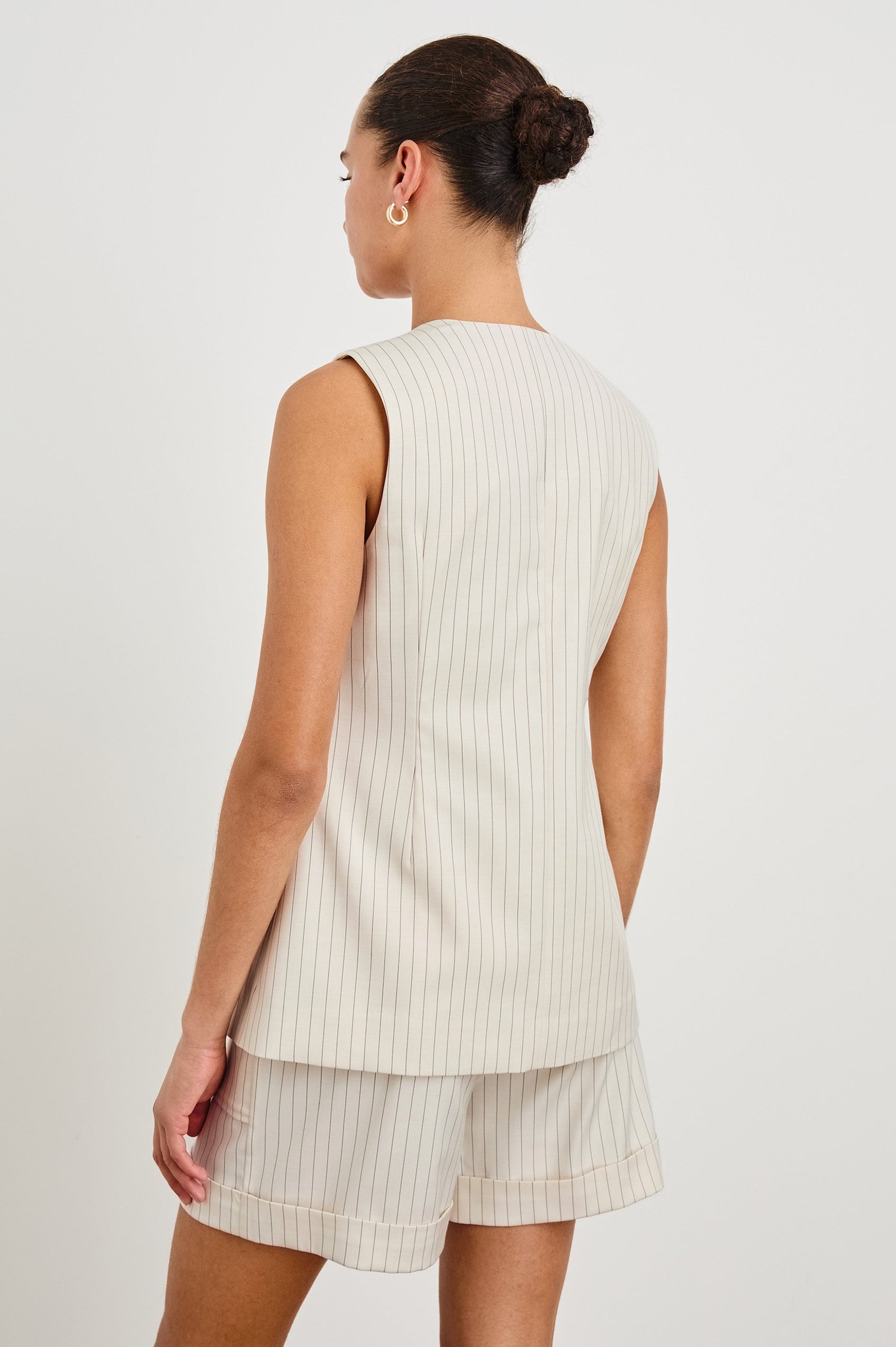 Mylah longline tan vest with black buttons in Birch Pinstripe - back view on model