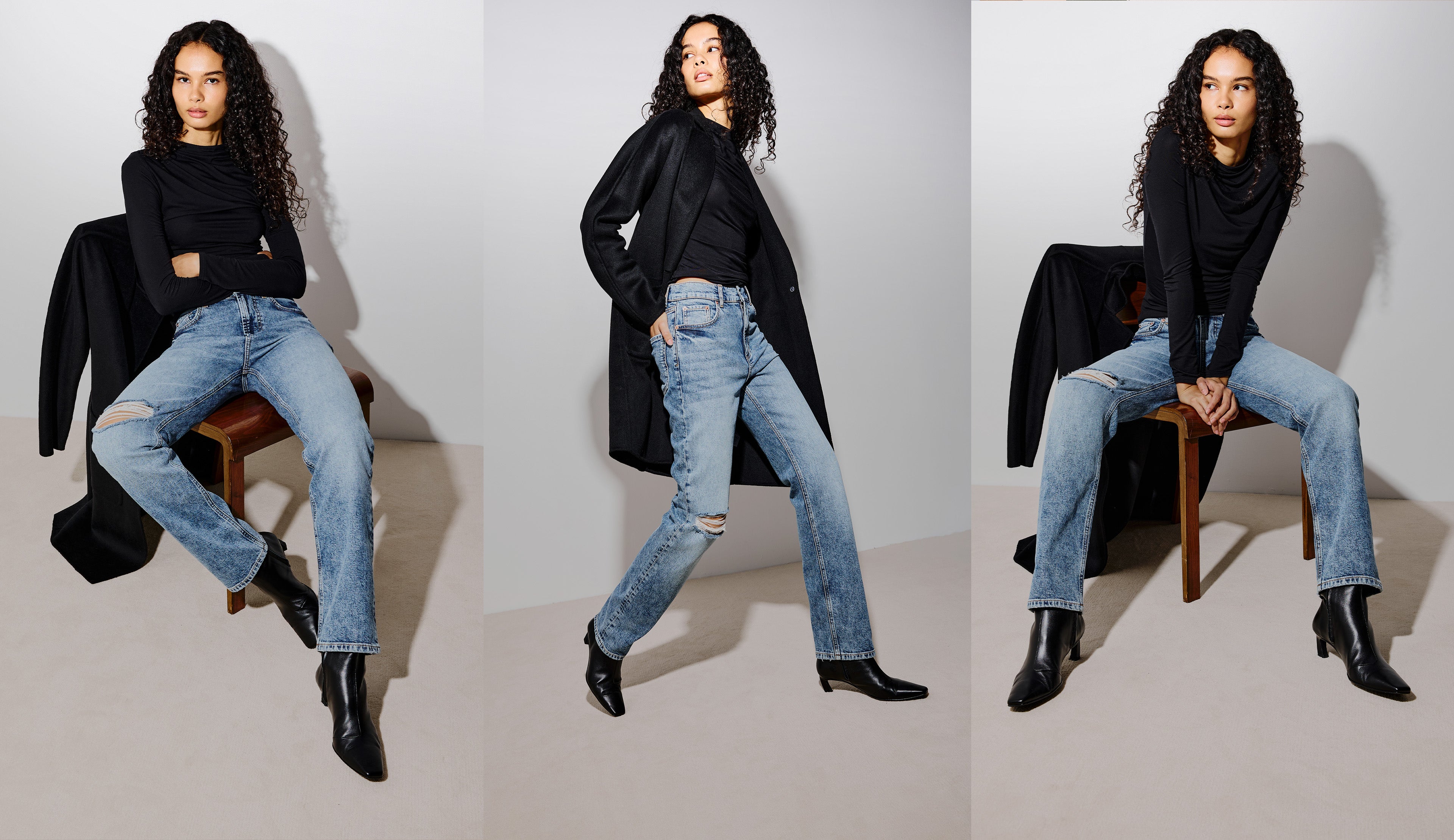 A three-panel studio fashion photo showing a model wearing light-wash distressed blue jeans, a black long-sleeve top, and black ankle boots, posed while sitting on and standing beside a wooden chair against a light gray backdrop.