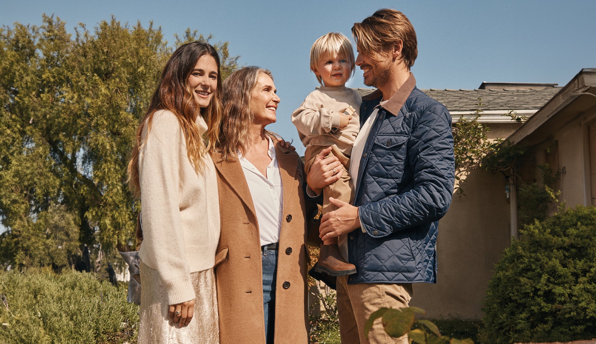 EDITORIAL IMAGE OF FAMILY OUTSIDE DRESSED FOR THE HOLIDAYS