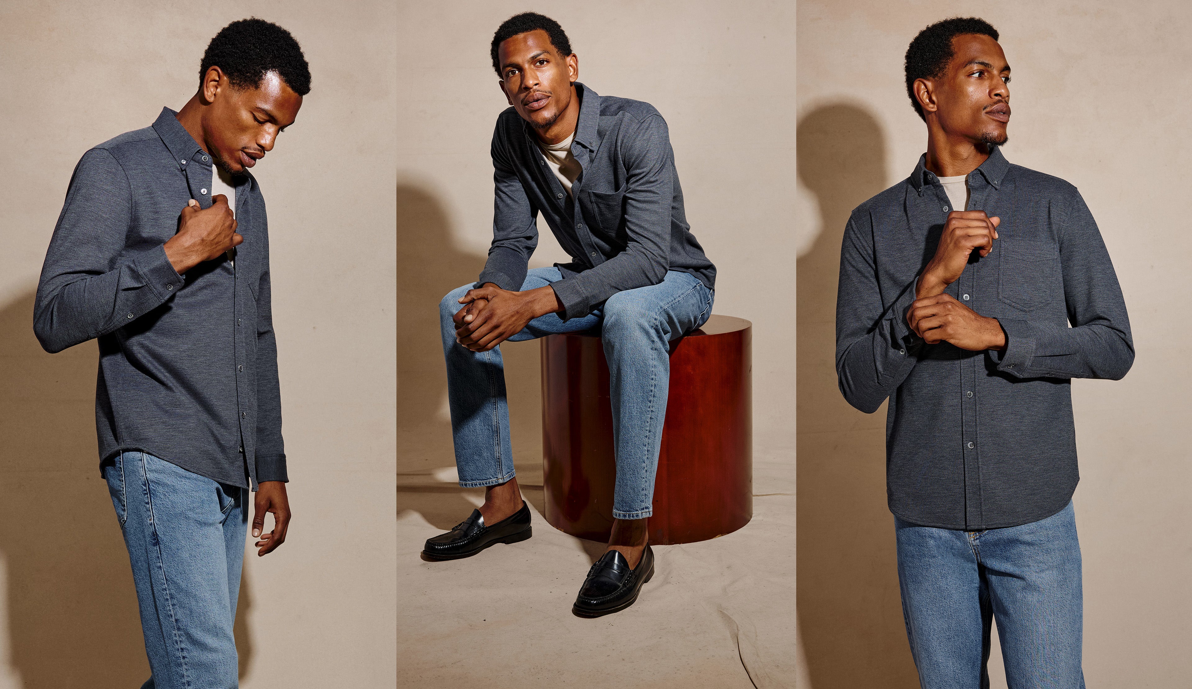 A three-panel studio fashion photo of a man wearing a dark blue-gray long-sleeve button-up shirt with light blue jeans. In the left panel, he stands and adjusts the shirt collar.
