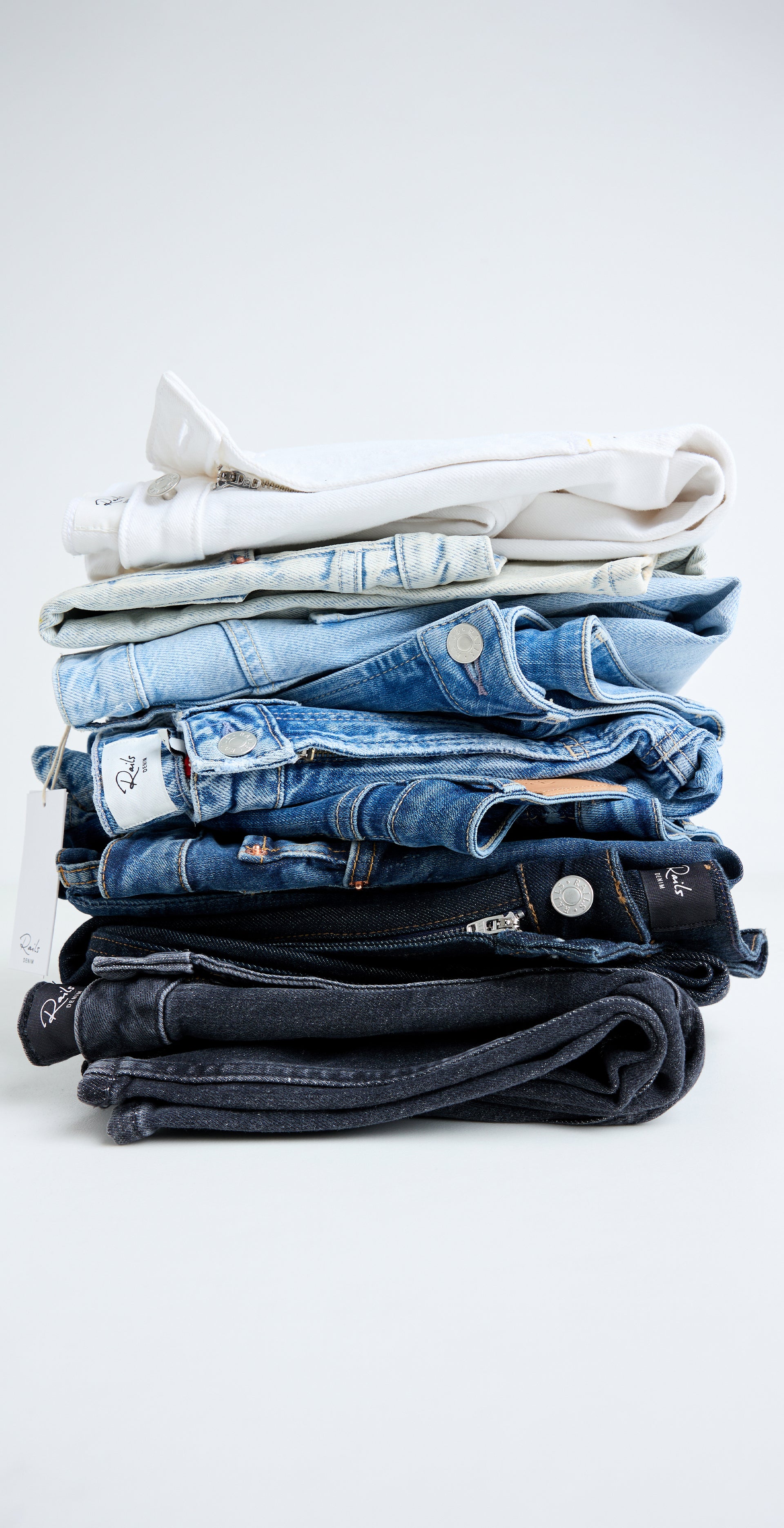 Different shades of denim stacked on top of each other