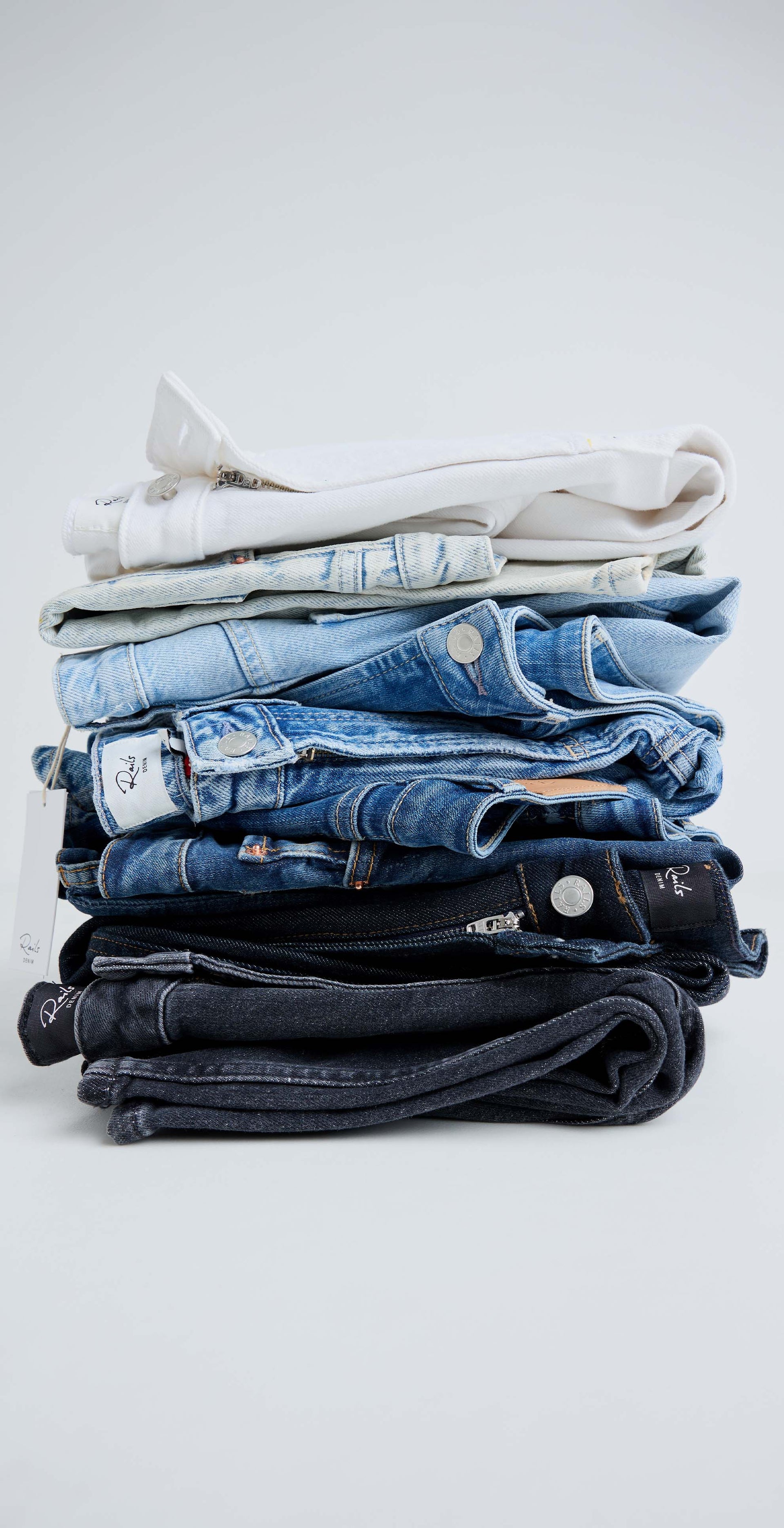 Stacked pair of different colored jeans
