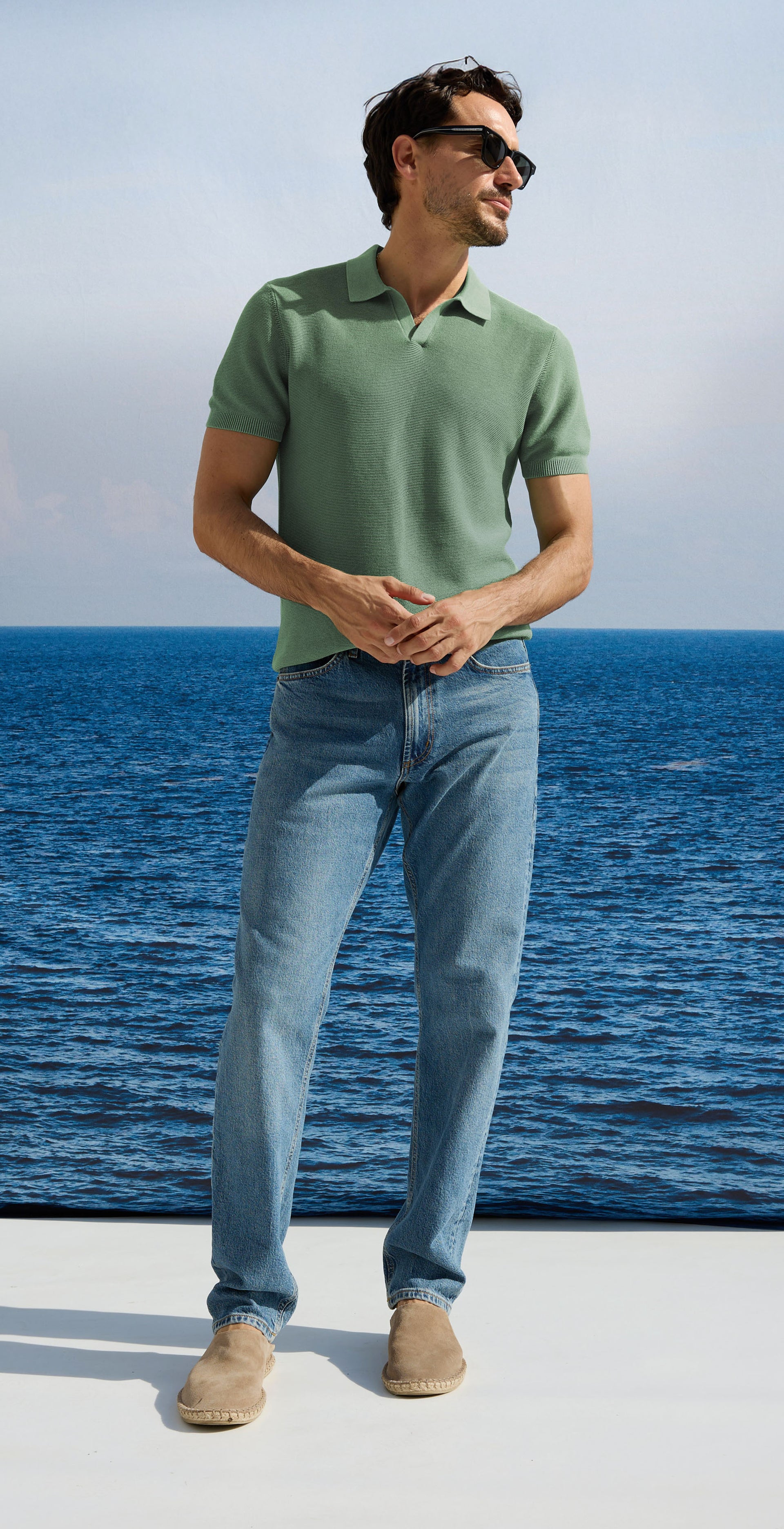 Man in a green shirt and blue jeans