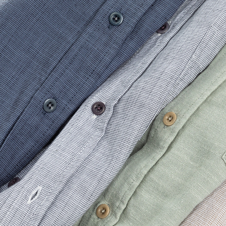 CLOSE UP IMAGE OF THREE BUTTON DOWN SHIRTS SHOWING THE FRONT BUTTONS