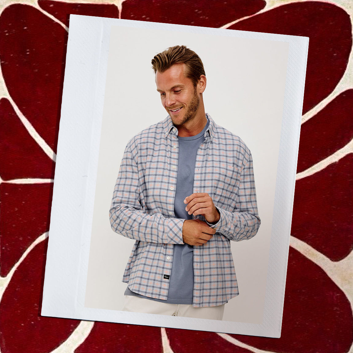 Man wearing a plaid shirt over a blue t-shirt on a white background