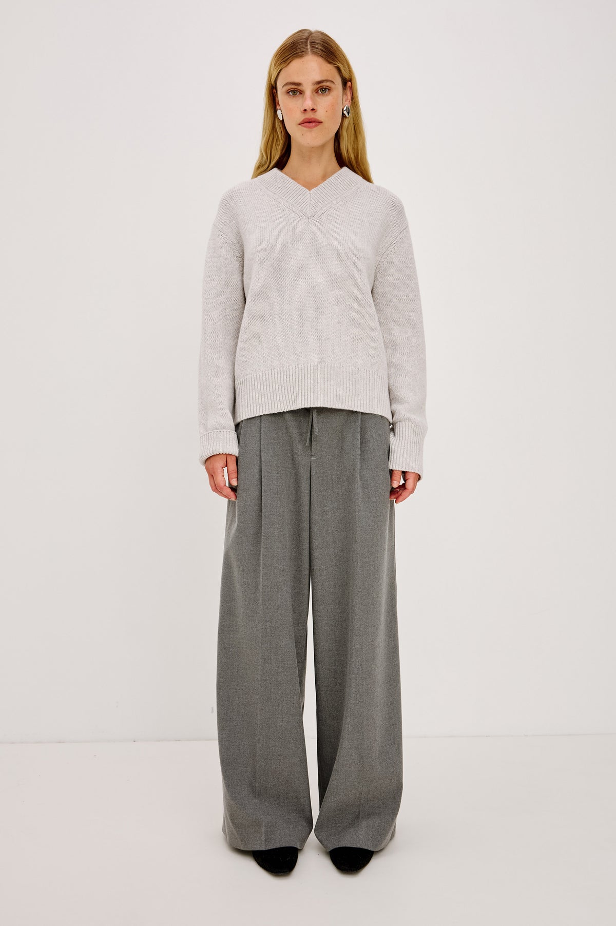 Nando Pant in Drapey Suiting Blend With High Waist, Wide, Relaxed Legs, and Drawstring Ties in Heather Charcoal Colorway - Front Full Body View Featured on Model.