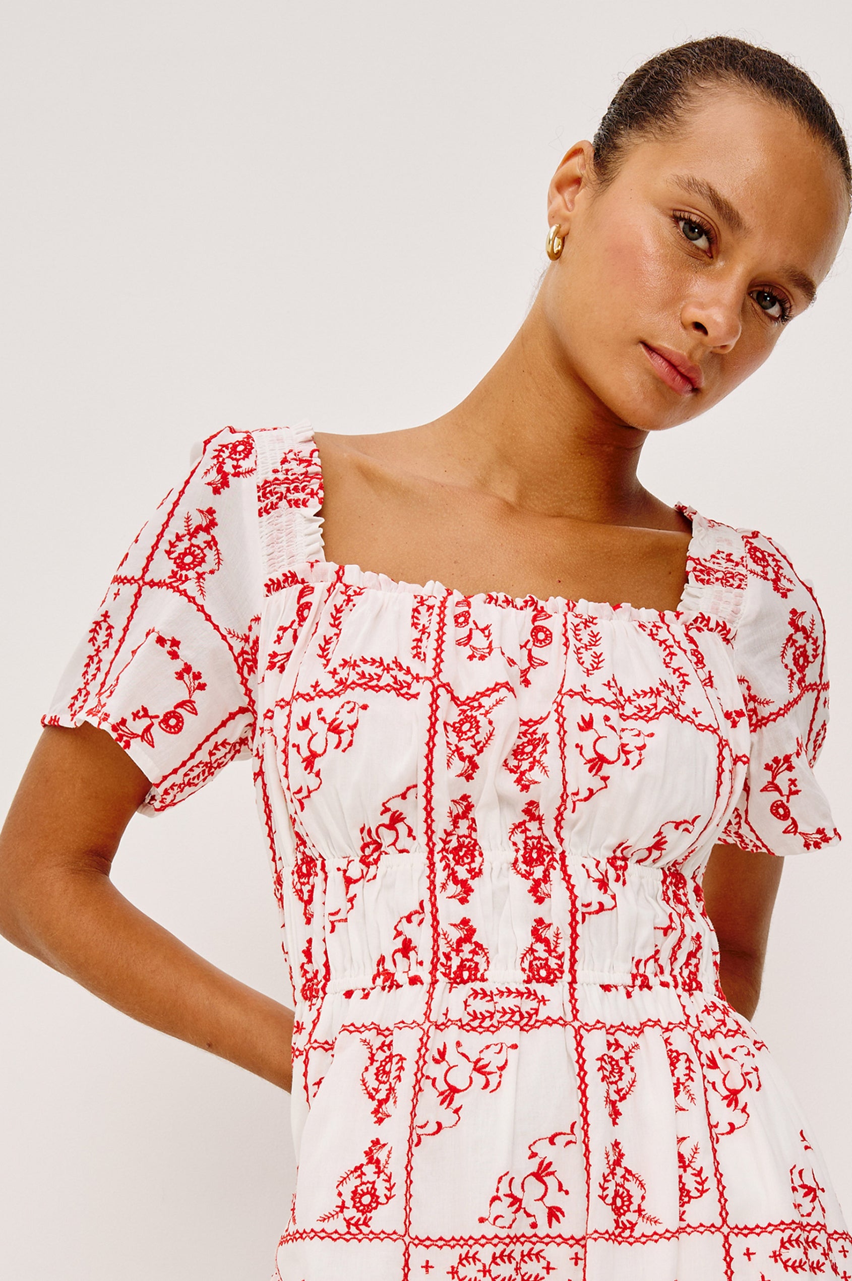 Nanette Midi Dress in Cotton Voile With Square Neckline, Underbust Elastic, Smocked Detailing, Short Sleeves, and is Fully Lined in Ivory Red Handkerchief Colorway - Upper Body Front View Featured on Model