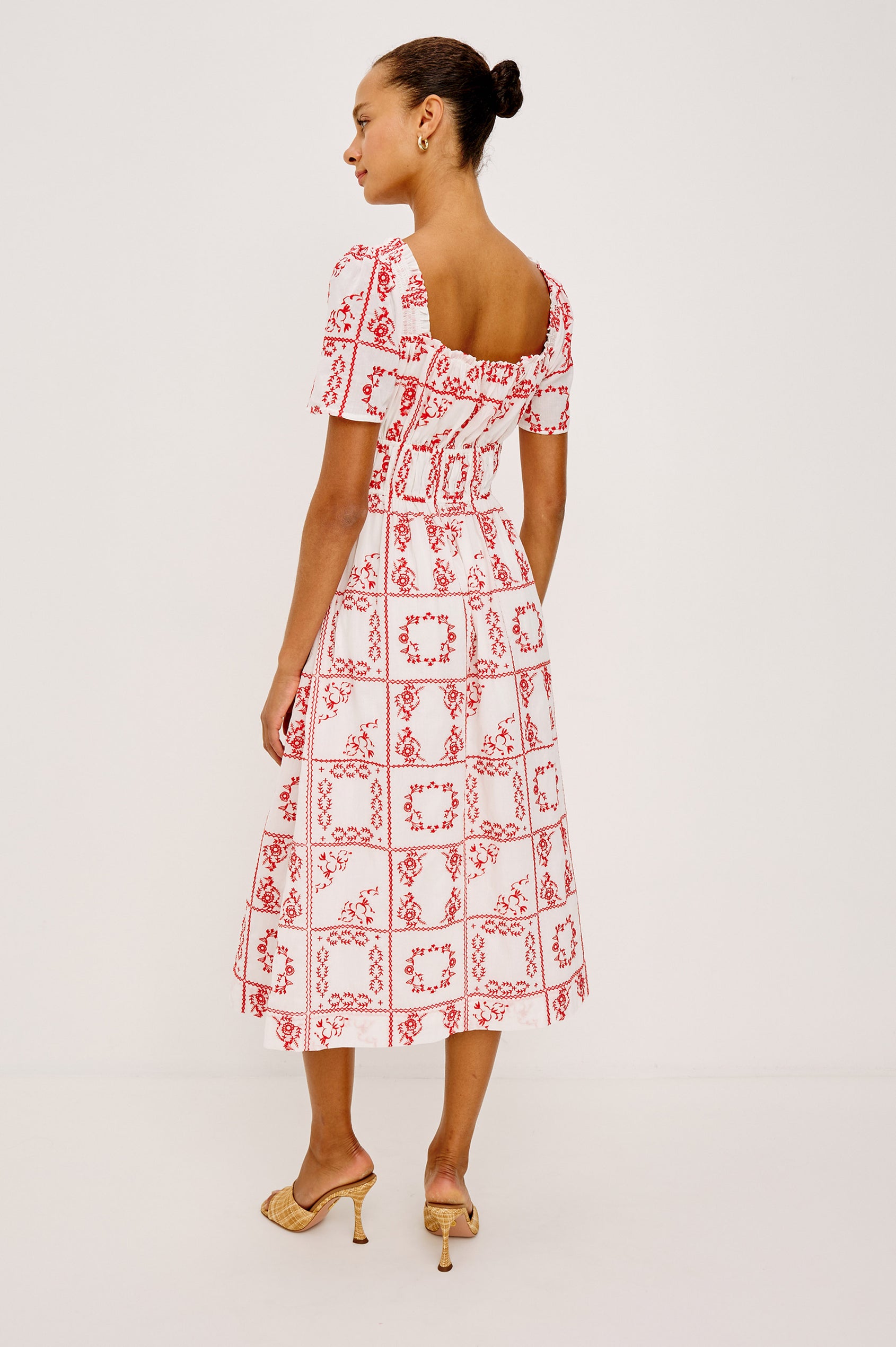 Nanette Midi Dress in Cotton Voile With Square Neckline, Underbust Elastic, Smocked Detailing, Short Sleeves, and is Fully Lined in Ivory Red Handkerchief Colorway - Full Body Back View Featured on Model