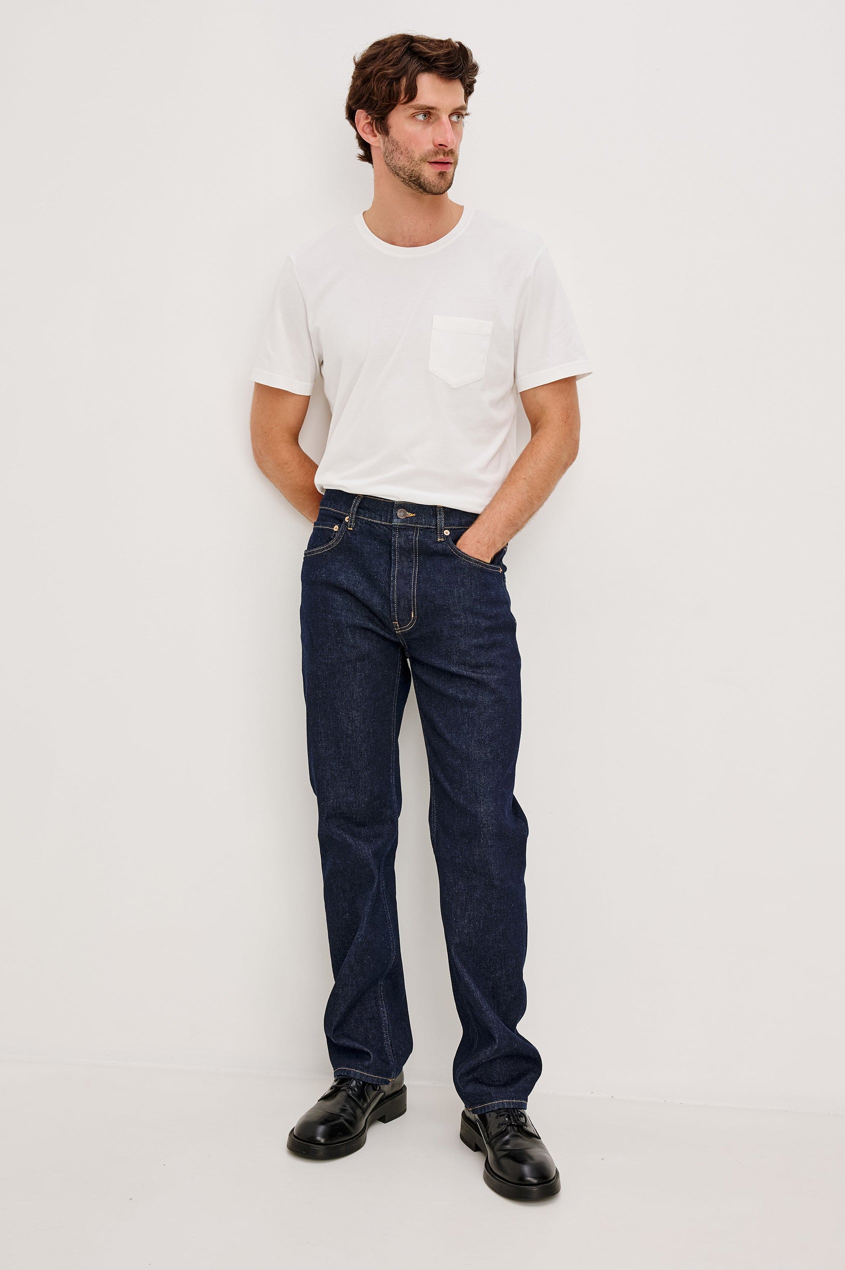 Nash is a straight leg 5-Pocket denim jean a zip fly and button closure as well as rivets in a Rinse Wash. Front full body view featured on model.