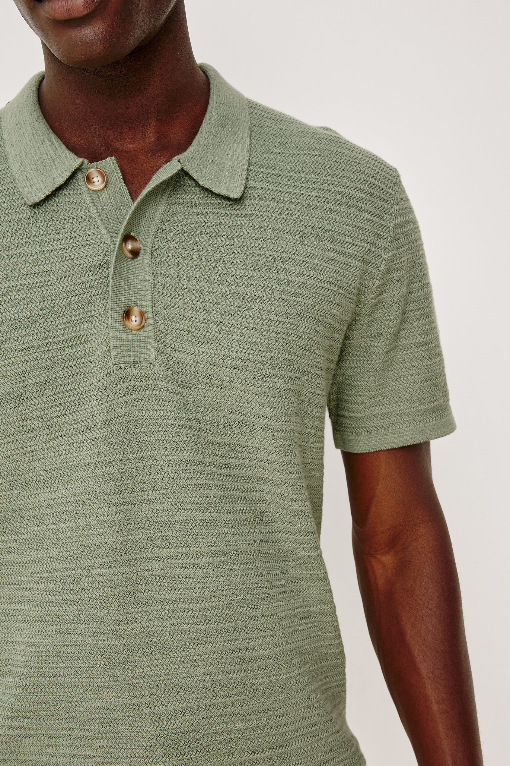 Nathan Polo Shirt in Cotton Blend Knit With Collar, Quarter Button Placket, and Short Sleeves in Silver Sage Colorway - Upper Body Front Close Up View Featured on Model