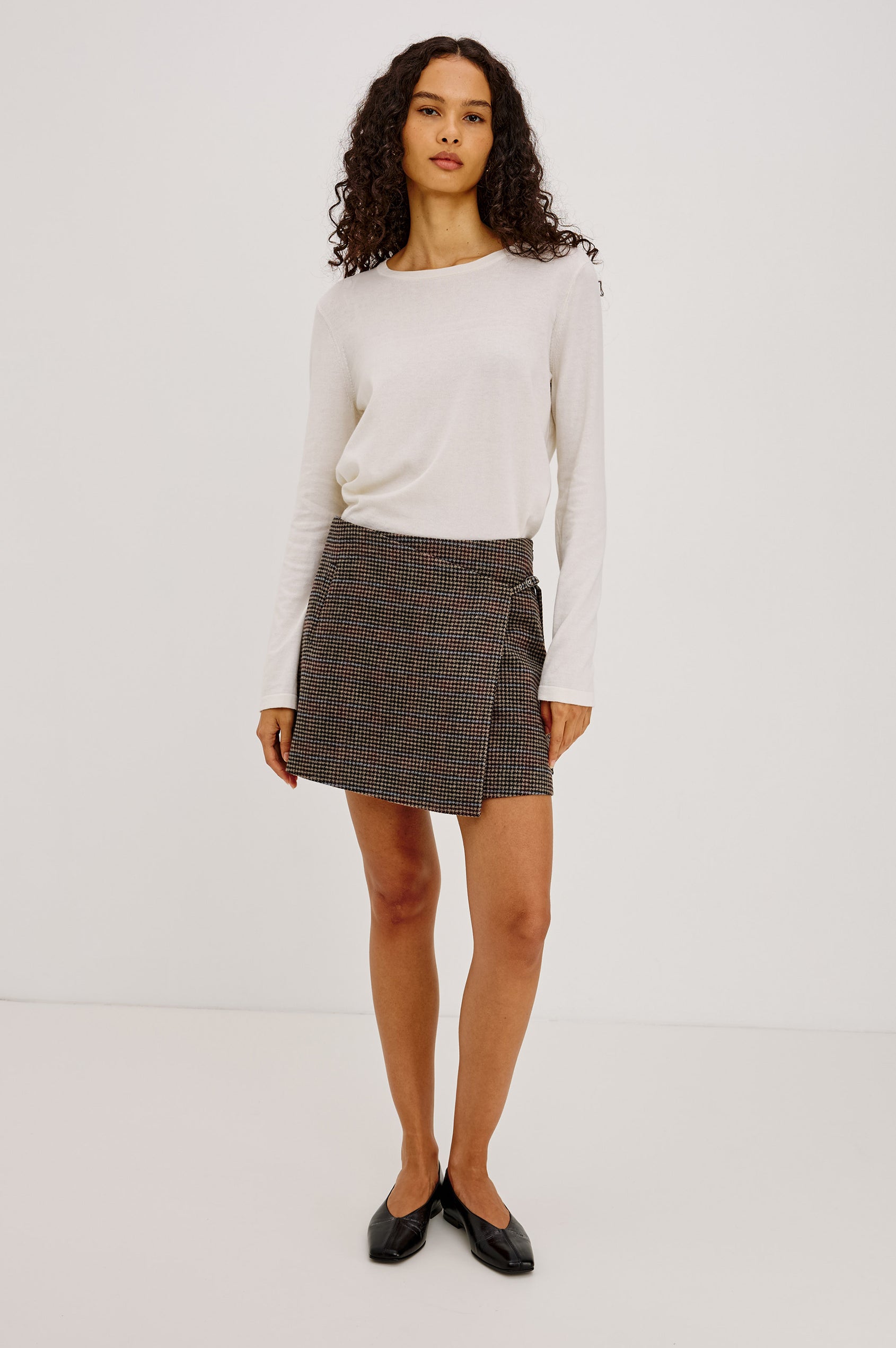 Nial Mini Skirt in Wool Blend With Wrap Front, Buckled Side Strap, Side Welt Pocket, Seam Zip Closure, and Fully Lined in Oxford Plum Colorway - Full Body Front View Featured on Model