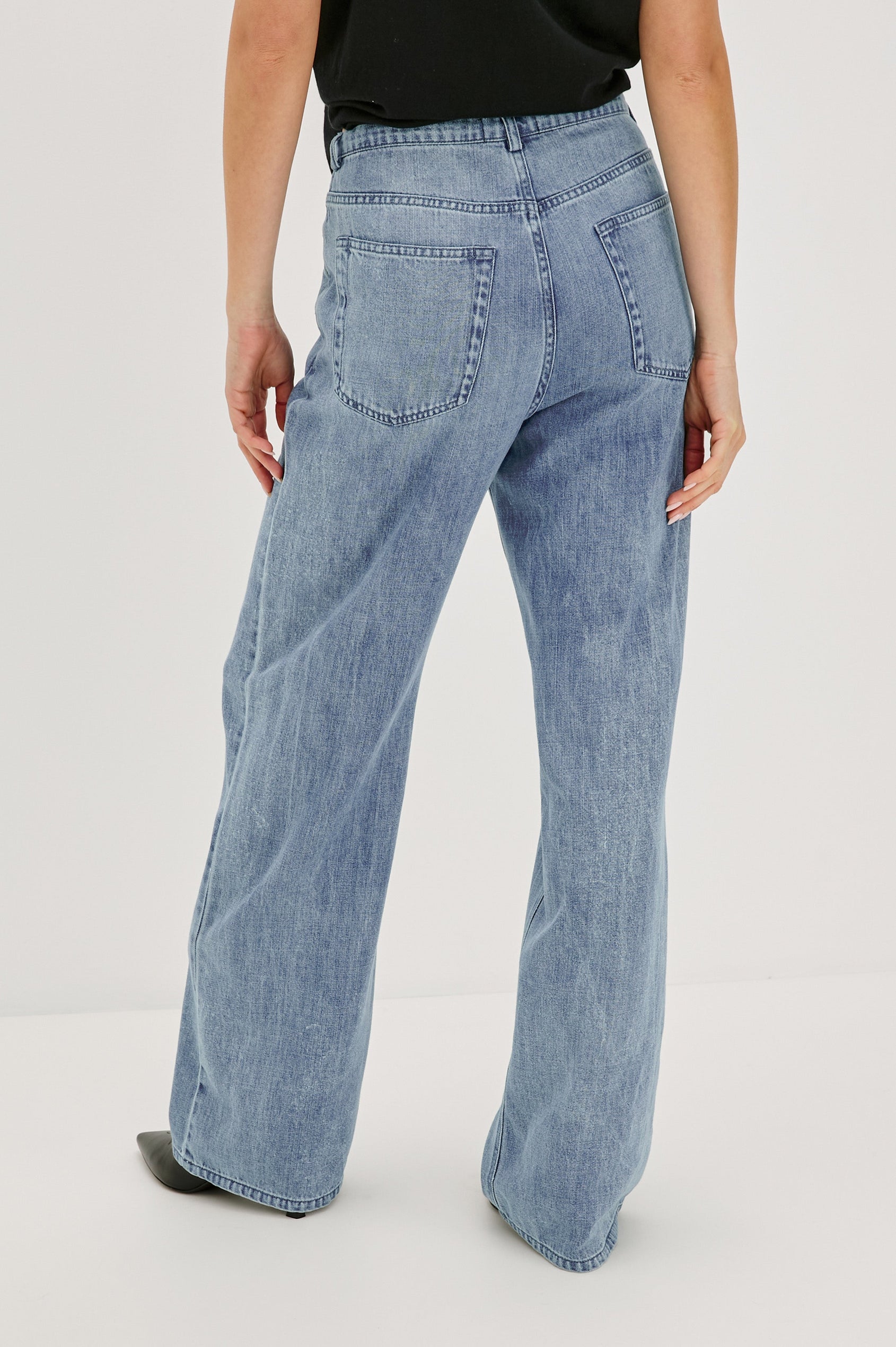Normandie Lightweight 5-Pocket Denim Wide Leg Pant with front zipper button fly and a drawstring tie at waist in Antique Blue Colorway. Back View Featured on Model.