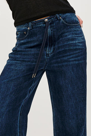 Normandie Lightweight 5-Pocket Denim Wide Leg Pant with front zipper button fly and a drawstring tie at waist in Oceana Colorway. Close Up Front View Featured on Model.