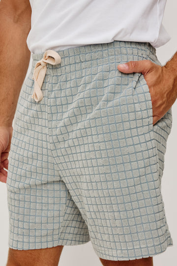 Nova Short in French Terry With Raised Jacquard Pattern, Side Pockets, and Drawstring Waist Ties in Silver Line Grid Colorway - Lower Body Close Up View Featured on Model