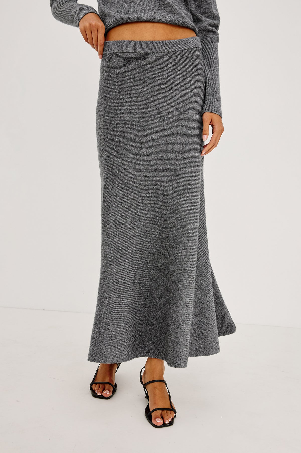 Odita Maxi Skirt in Soft Ribbed Wool Blend Knit With Elastic Waist, and A-Line Silhoeutte in Heather Charcoal Colorway - Crop Front View Featured on Model.